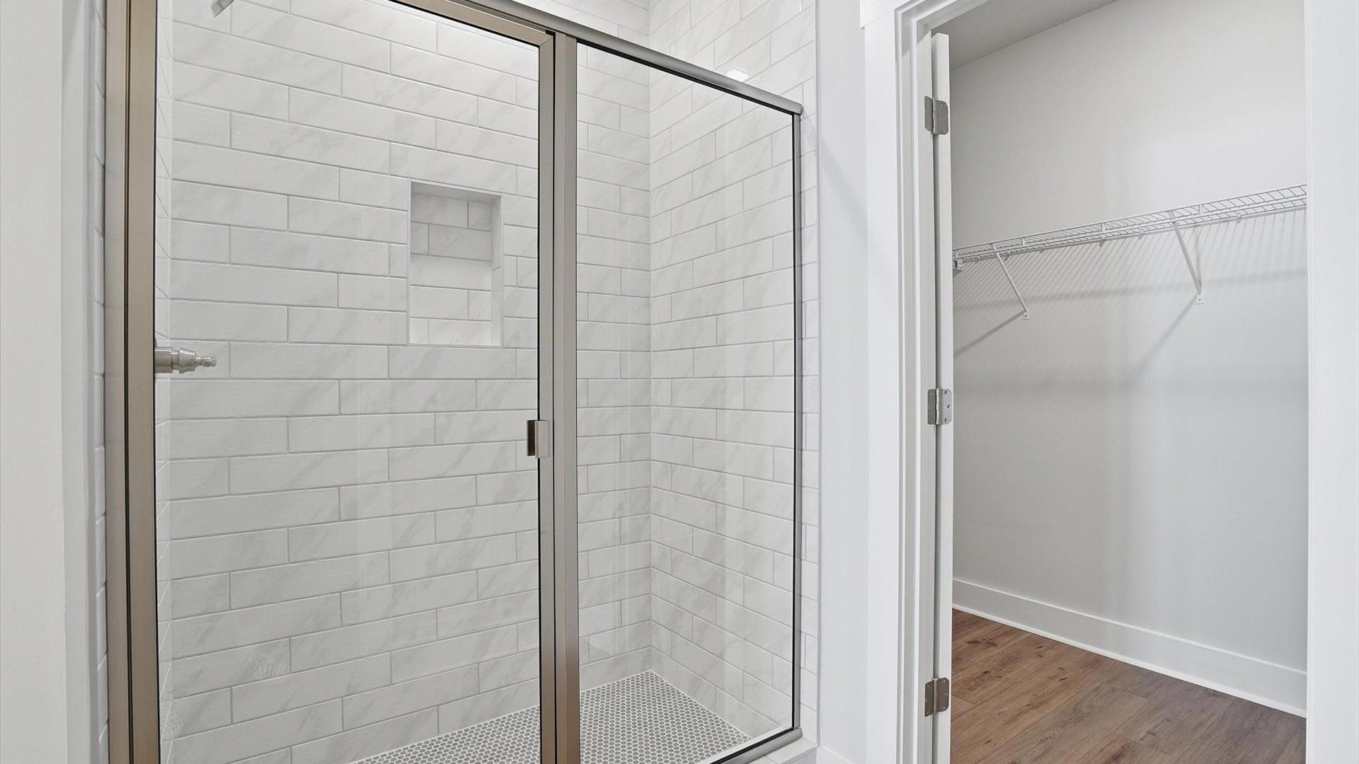Highly functional and elegant en-suite with dual vanities, tiled walk-in shower, and refined finishes at Village at Midway