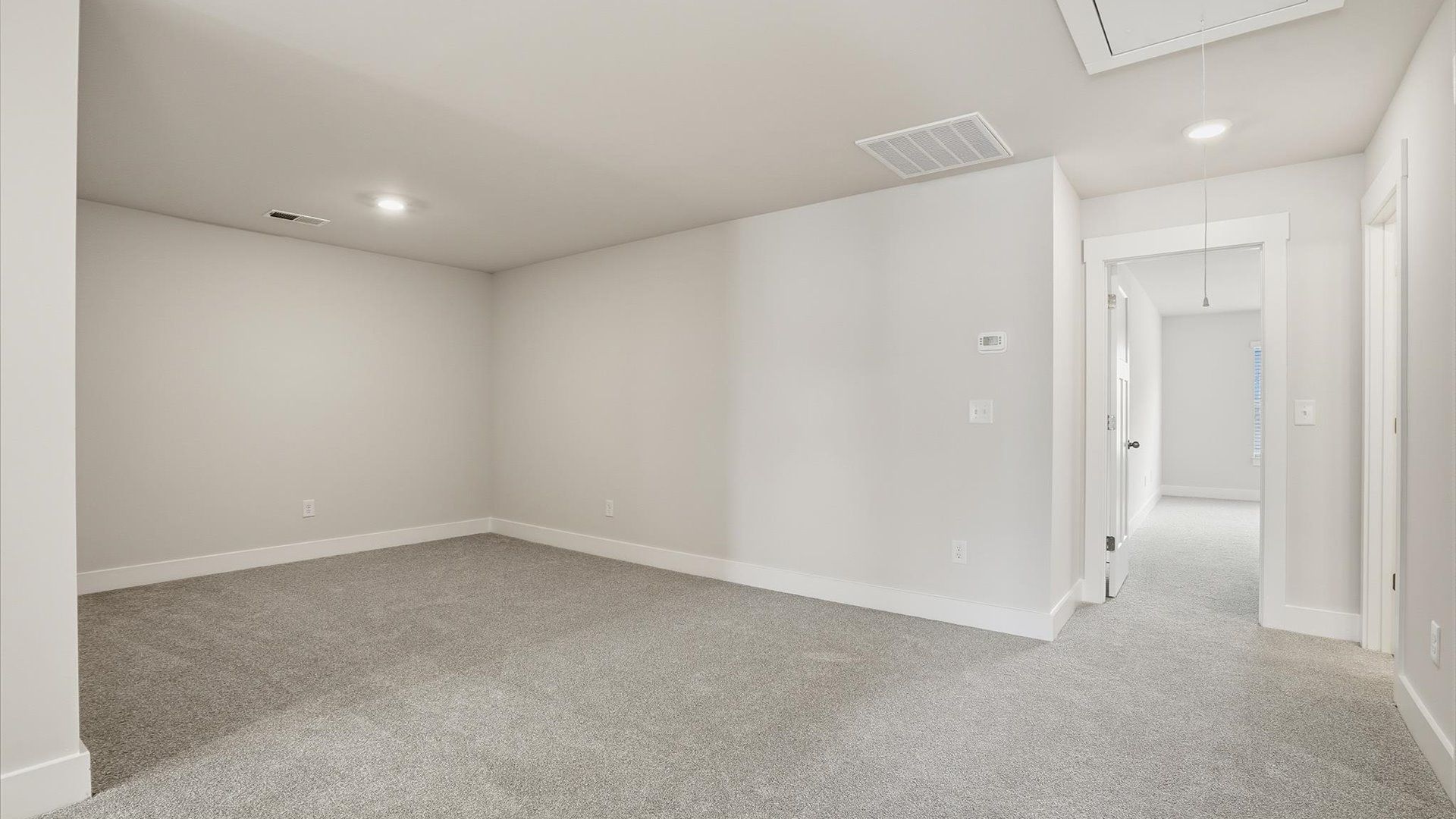 Vibrant carpeted loft offering flexibility as a study nook, game room, or second family space in Anderson, SC