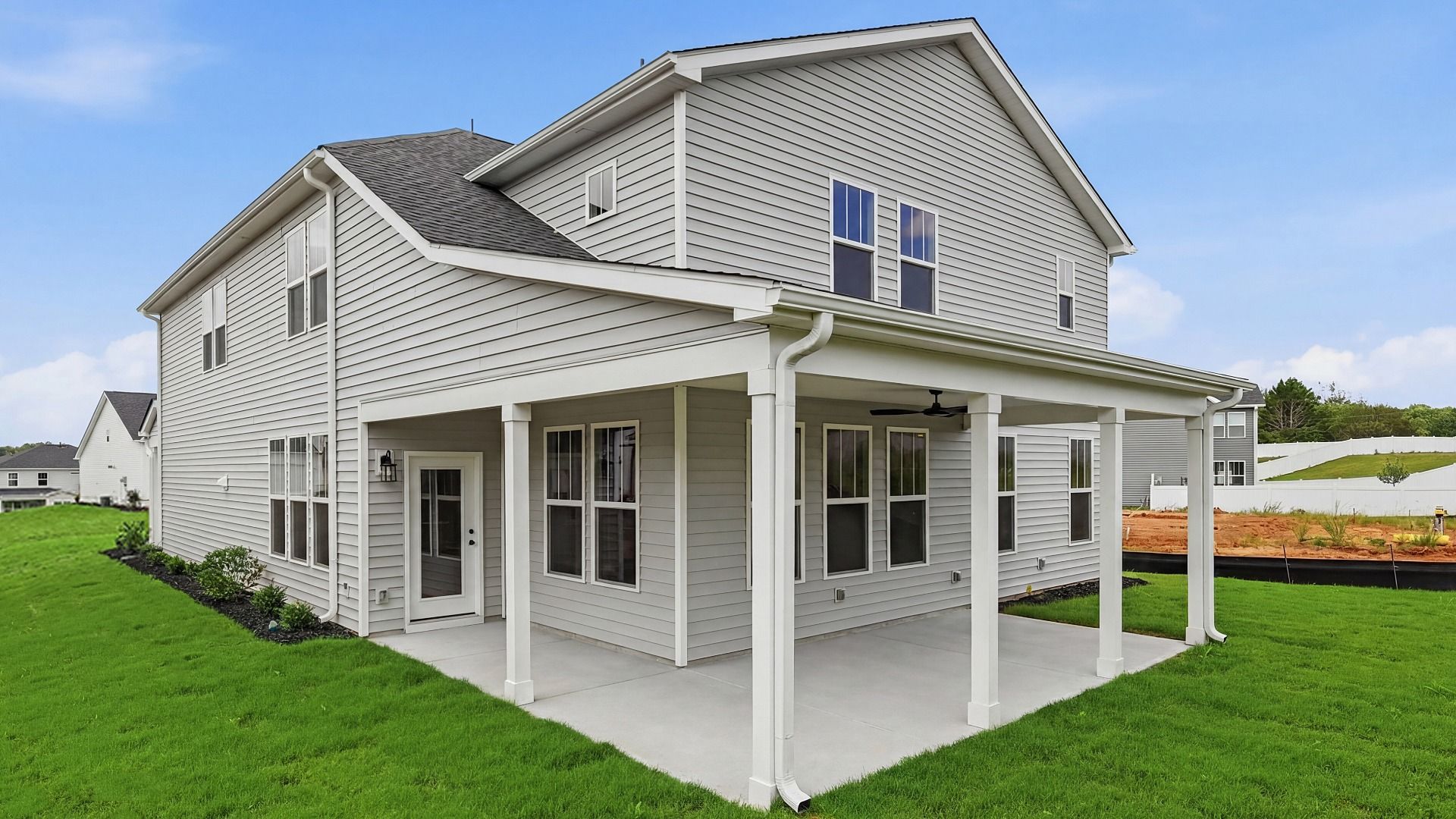 Notable exterior includes a rear covered porch designed for year-round enjoyment at the Woodglen community