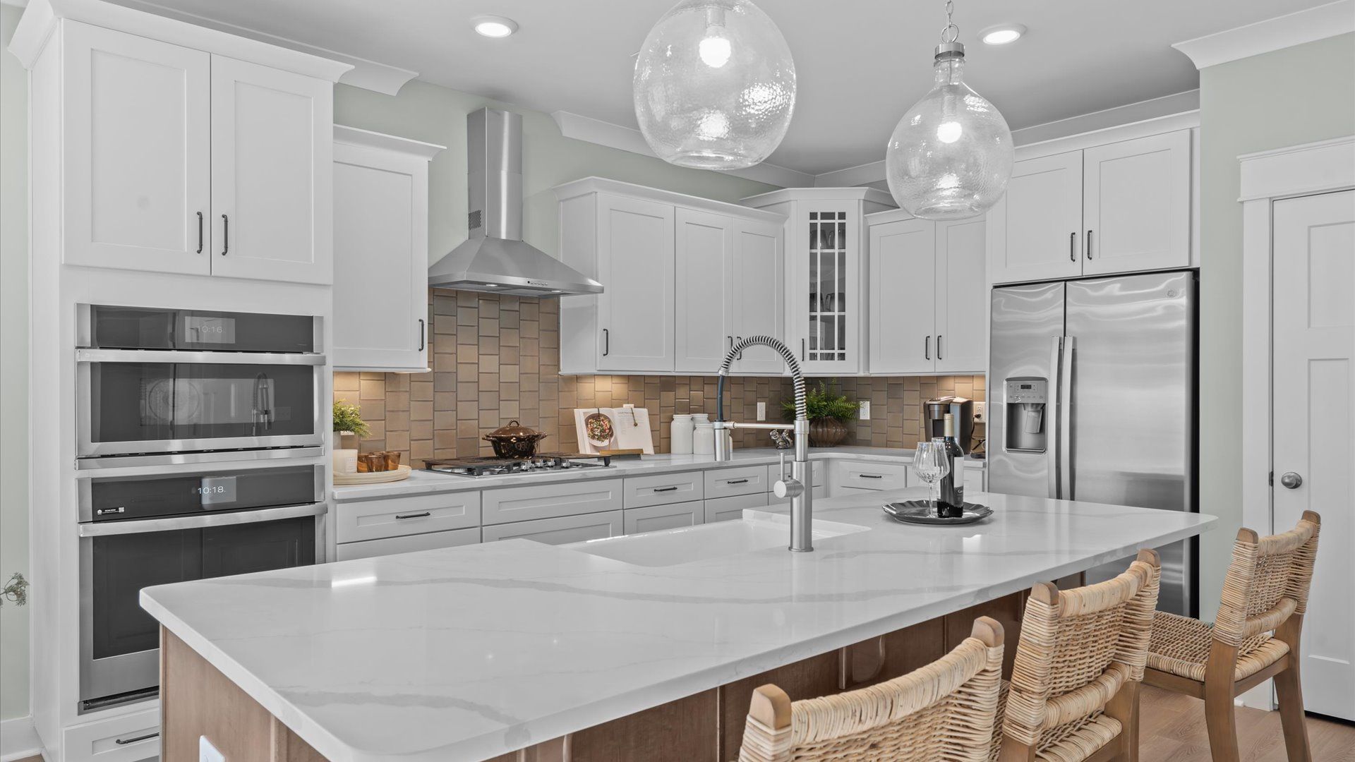 Exceptional kitchen featuring a spacious island, eye-catching pendant lights, and modern finishes by DRB Homes