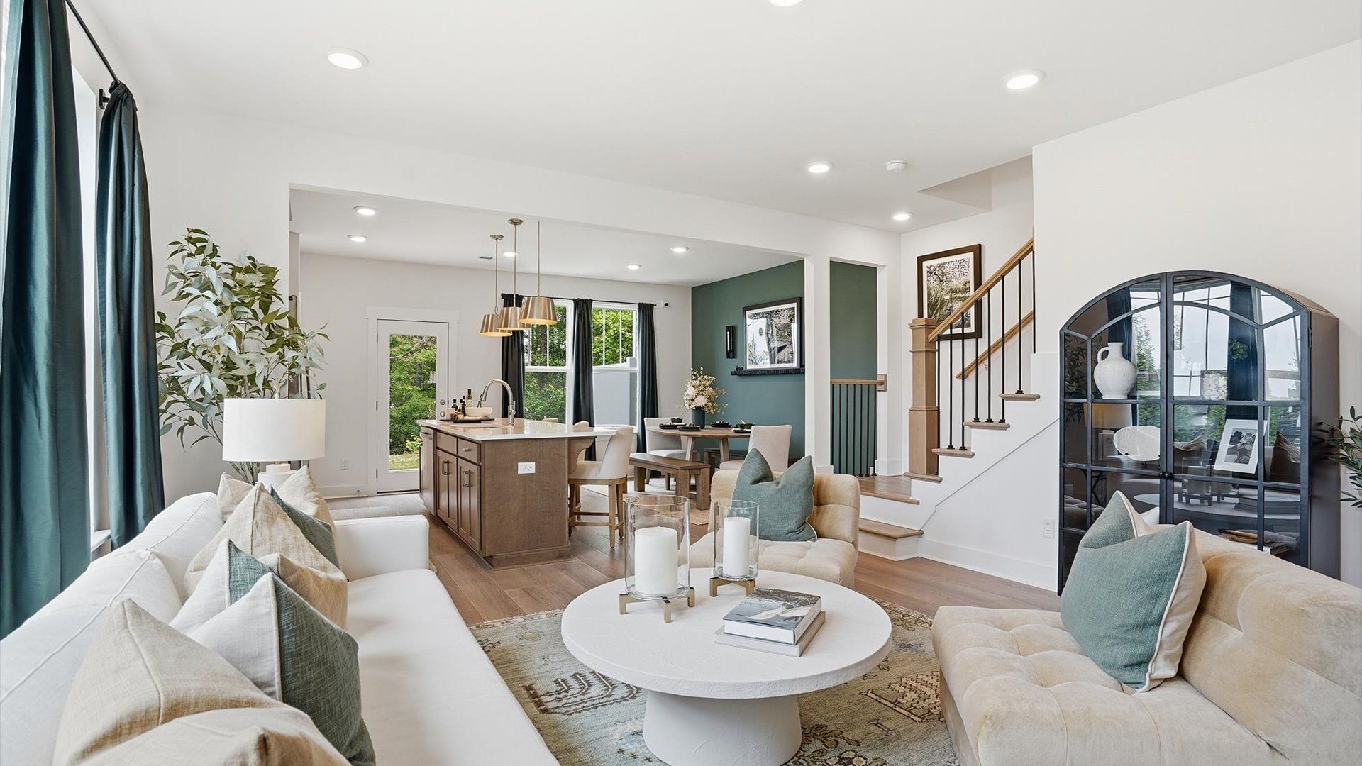 Hardwood flooring and high standards define this vibrant family room ideal for everyday living located at Hinson Farm