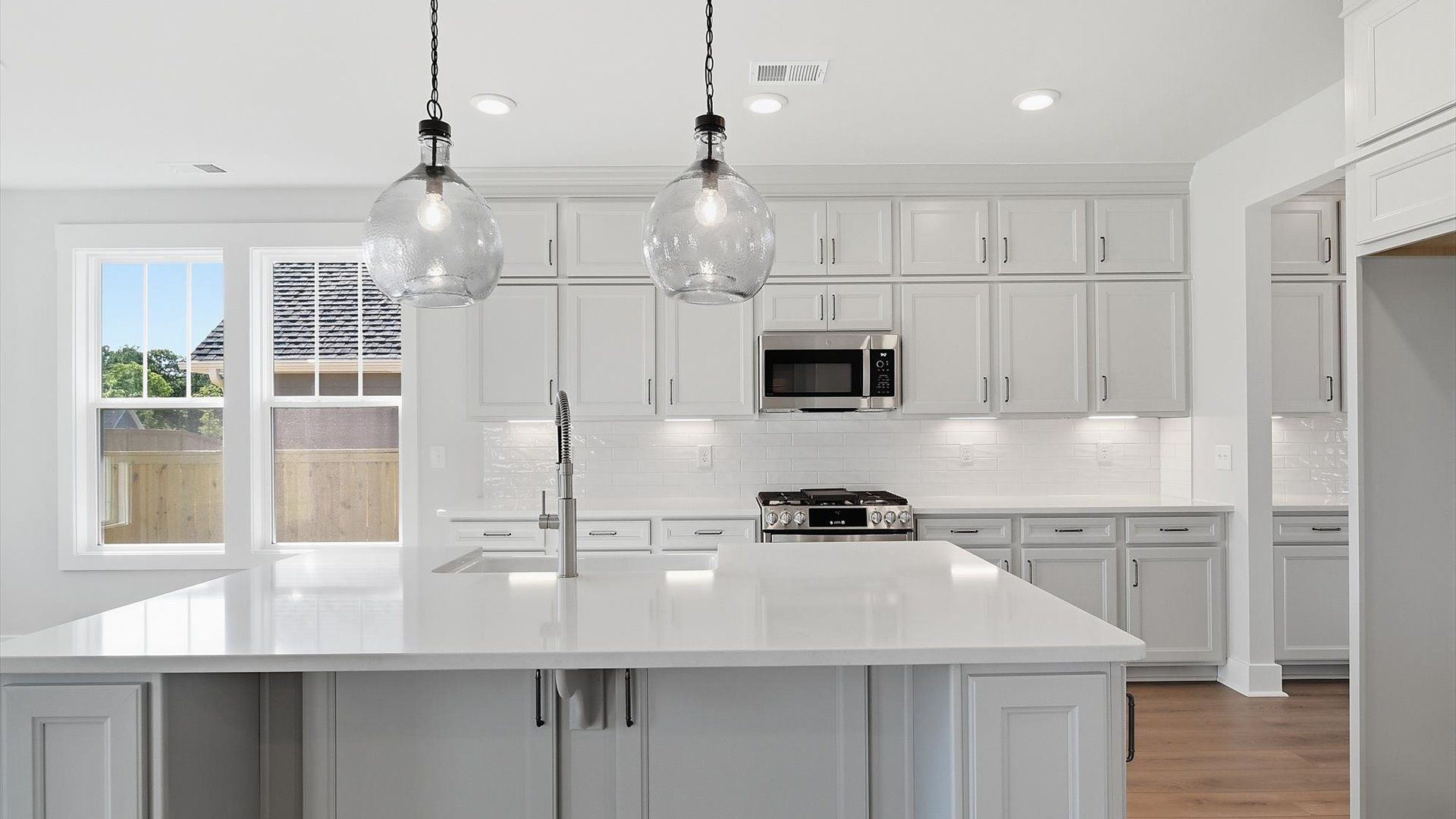 Notable kitchen space with elegant pendant lighting and a large island perfect for entertaining in Anderson, SC