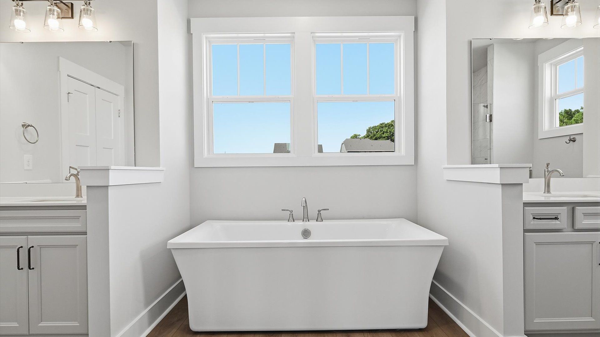 Exceptional en-suite with dual vanities and a large soaking tub for superior everyday comfort at Kayfield at Midway