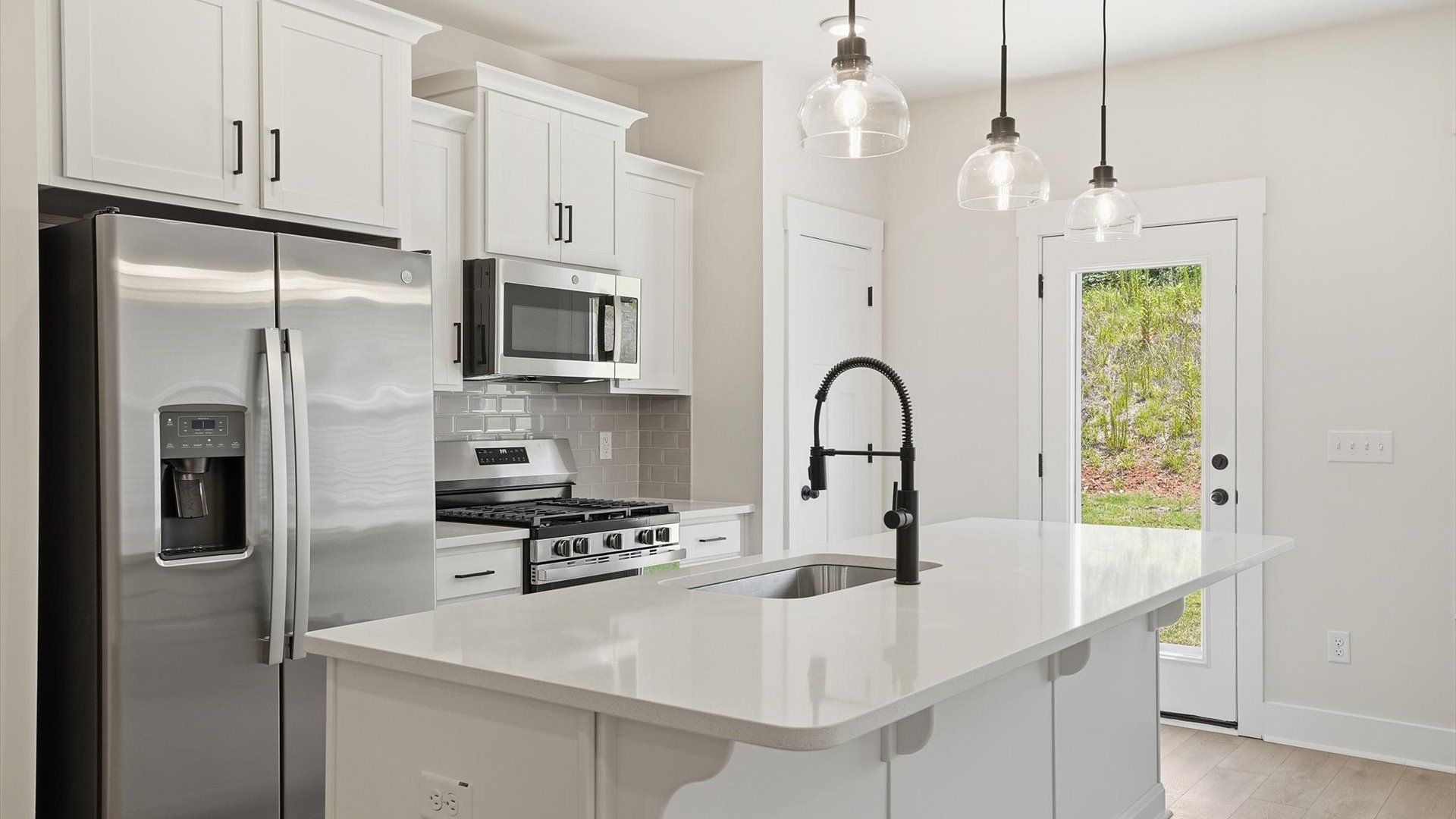 Notable kitchen space with elegant pendant lighting and a center island perfect for entertaining at Marion Square