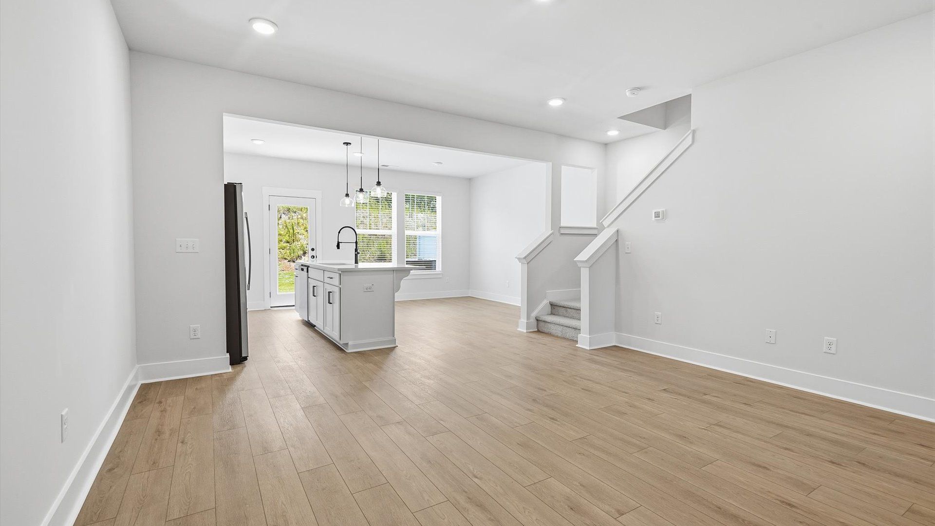 Memorable moments begin in this elegant, open family room with hardwood flooring and refined finishes