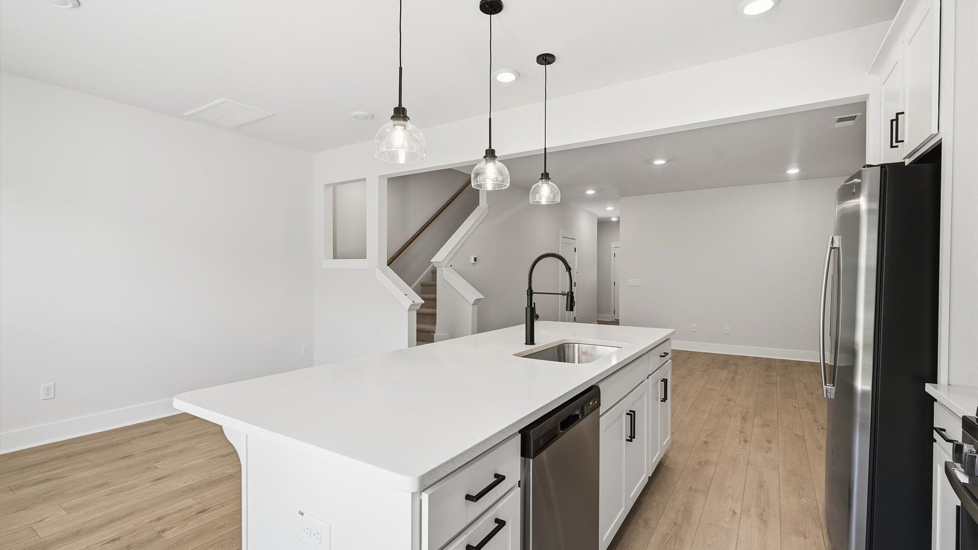 Highly skilled craftsmanship shines in this modern kitchen with pendant lighting and a central island focal point in SC