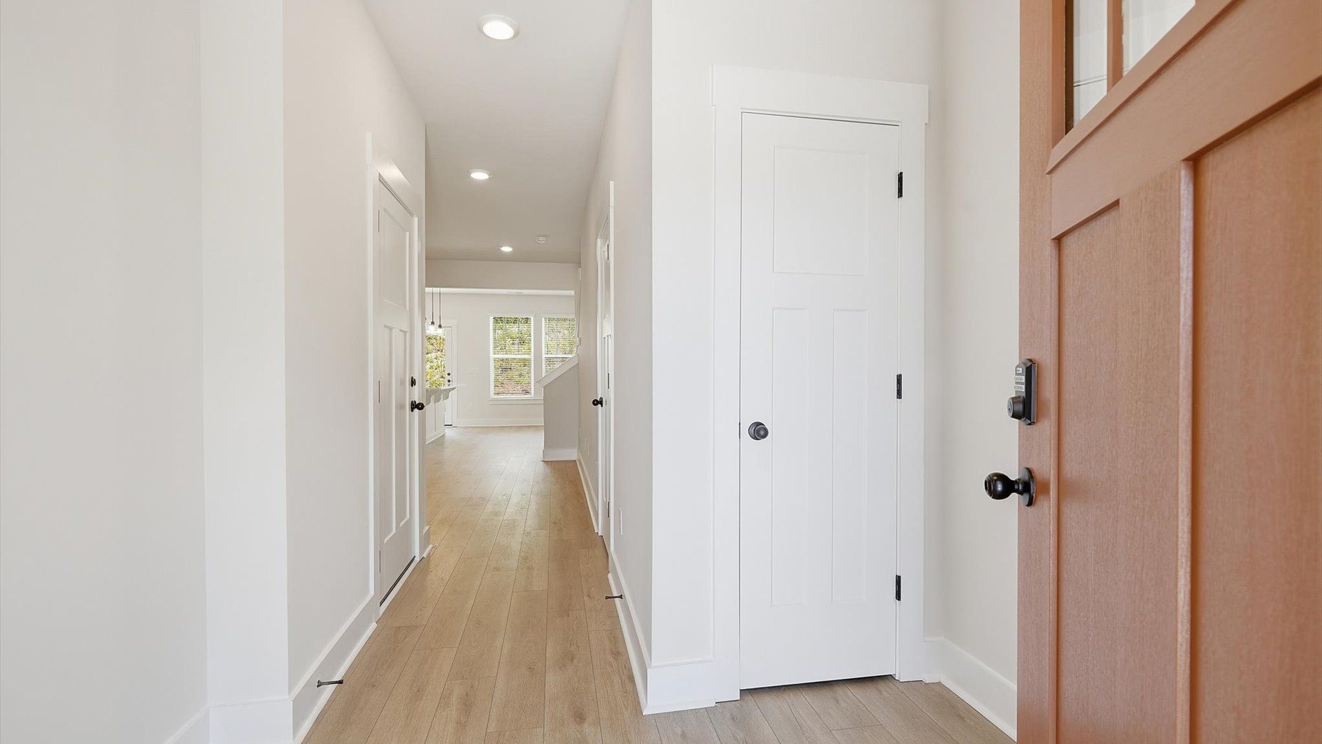 Memorable arrival experience with hardwood floors and elegant trim in the foyer at the Marion Square community