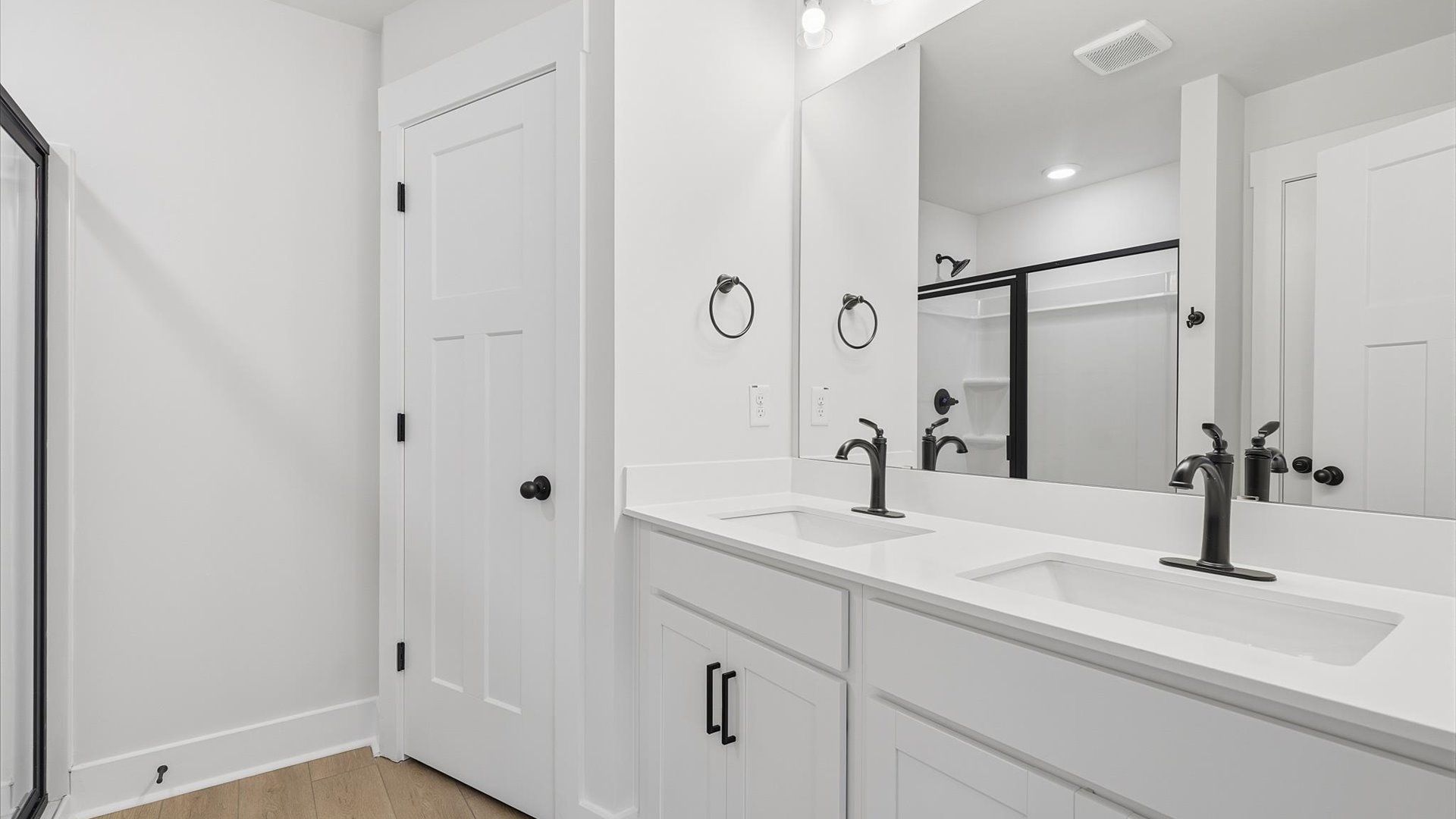 Accomplished design shines in this primary bath with dual vanity and a sleek walk-in shower at Marion Square