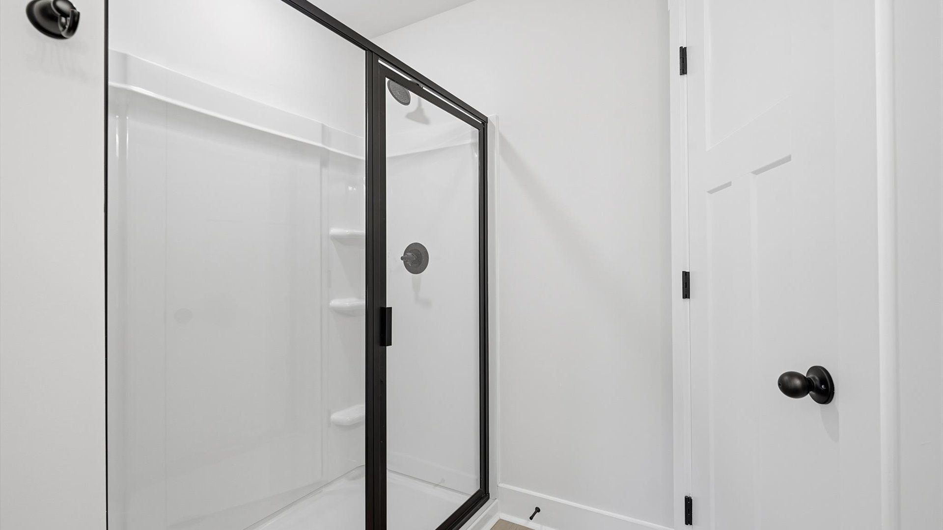 Highly functional and elegant en-suite with a tiled walk-in shower, and refined finishes by DRB Homes