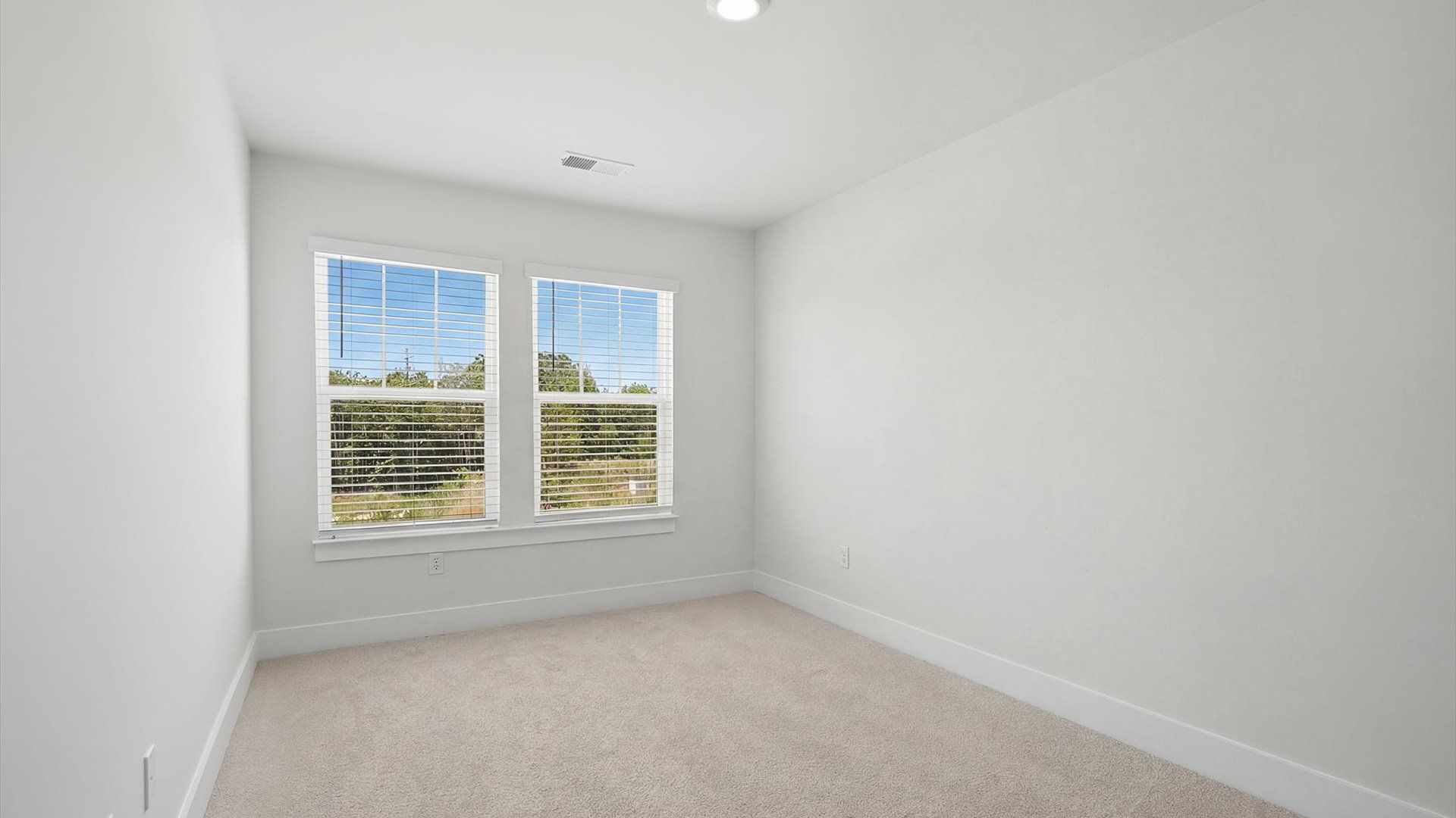 Vibrant and restful bedroom with oversized windows, refined detail, and a warm, welcoming atmosphere by DRB Homes