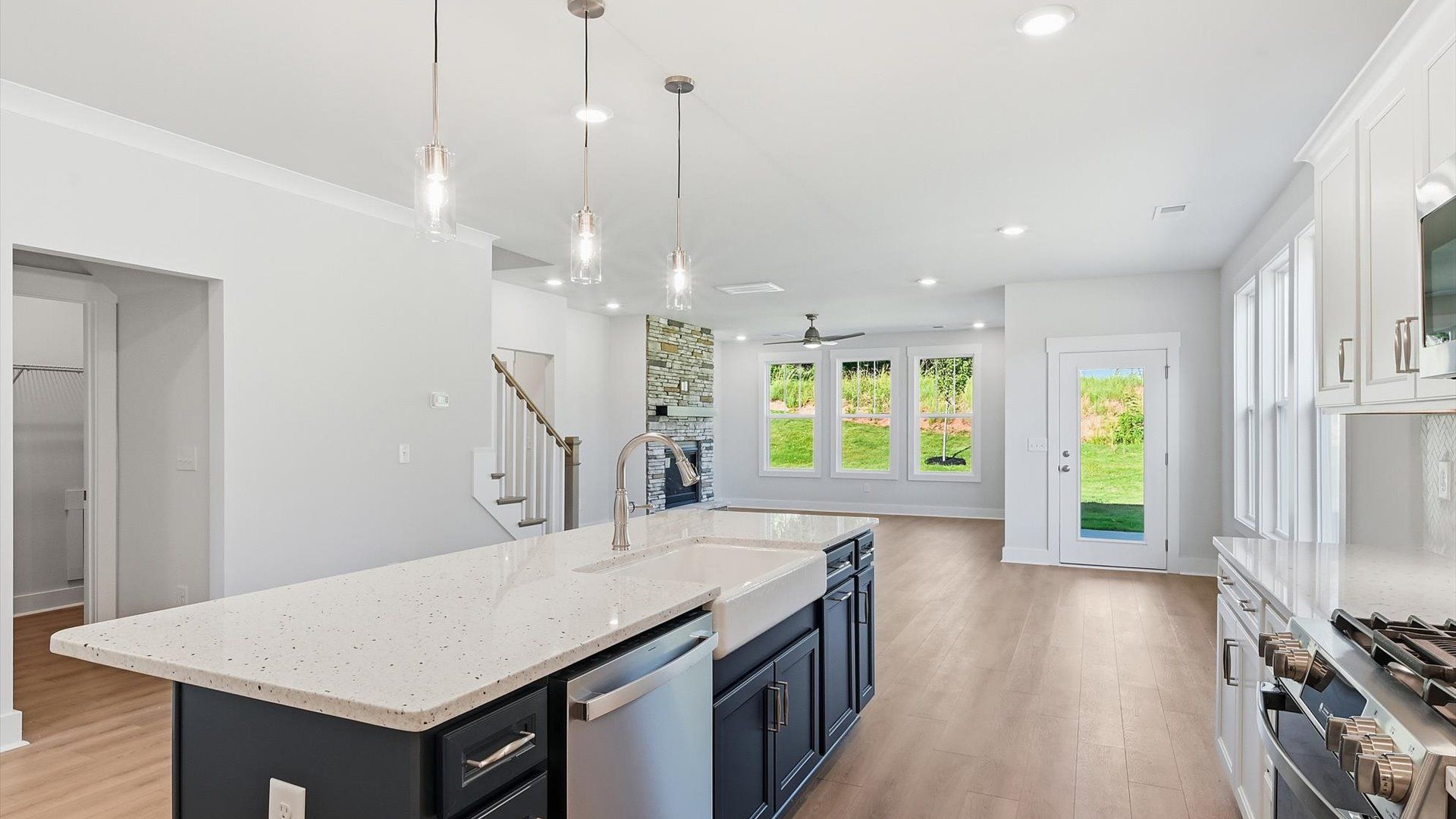 First-class kitchen with a spacious 9-foot island—perfect for entertaining beneath designer pendant lighting by DRB Homes