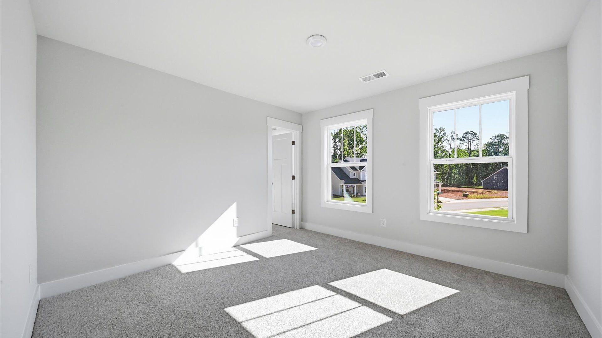 Refined bedroom design with large windows for daylight-filled mornings and peaceful views in Anderson, SC