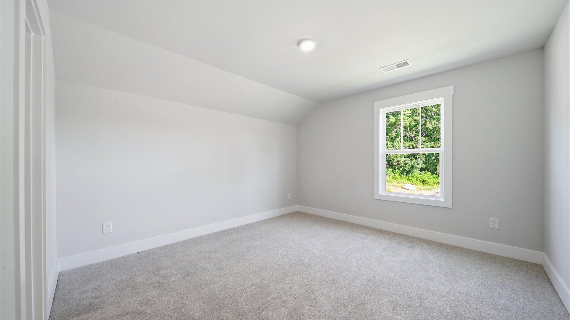 Memorable secondary bedroom walk-in closet, soft carpeting, and striking natural light from large windows in Anderson, SC
