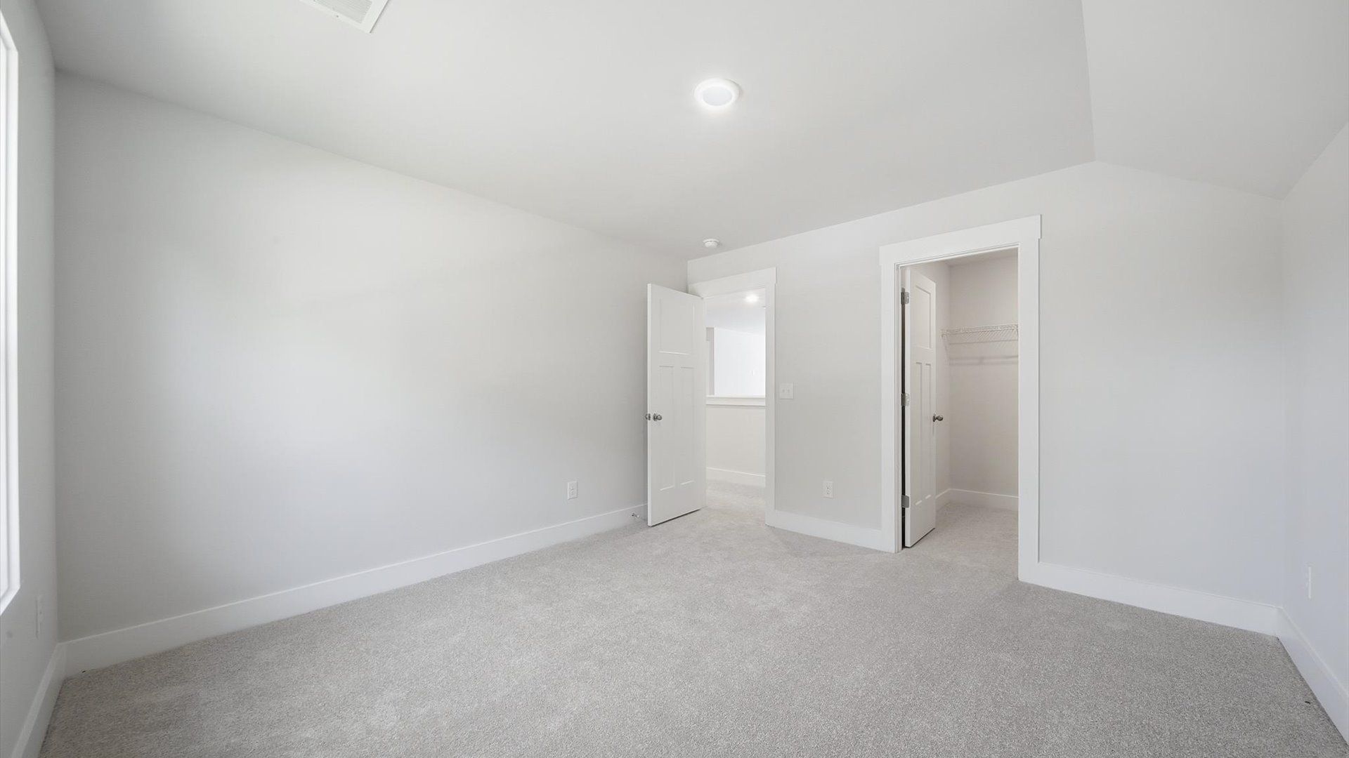 First-class secondary bedroom with comfortable carpeted flooring and generous closet space