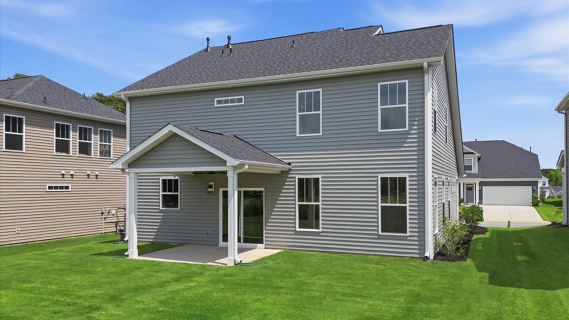 Exclusive rear covered porch with accomplished detail and elevated outdoor living potential at the Iris Meadows community