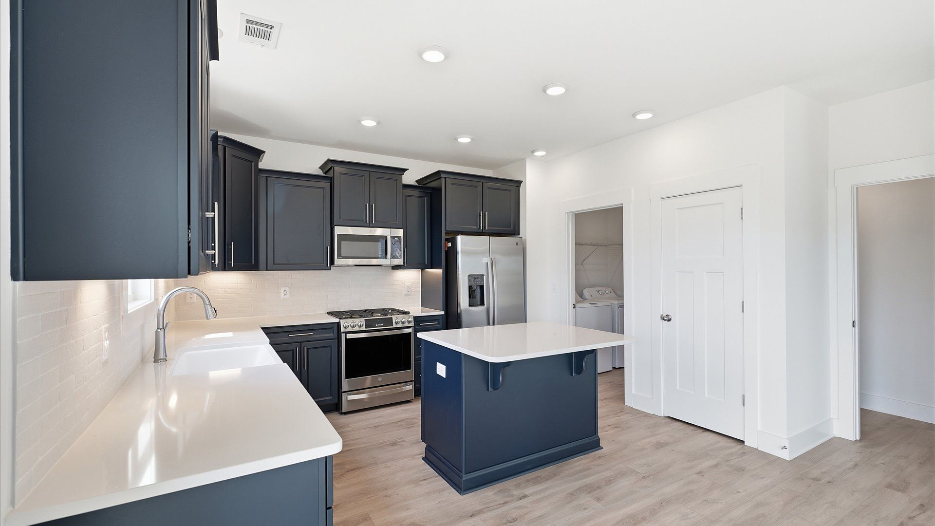 Memorable meals begin in this vibrant kitchen with a thoughtfully designed island located at Iris Meadows