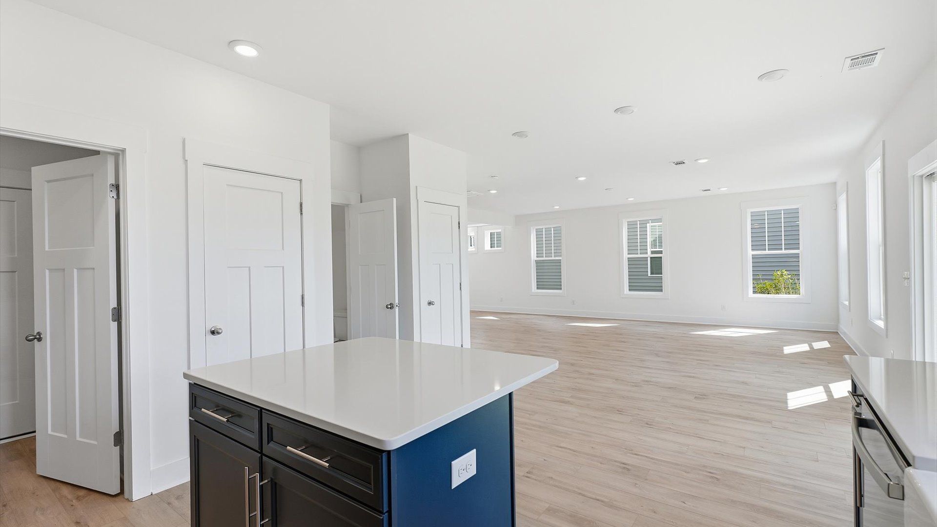 Vibrant kitchen layout with a center island, refined finishes, and open-concept flow at Iris Meadows