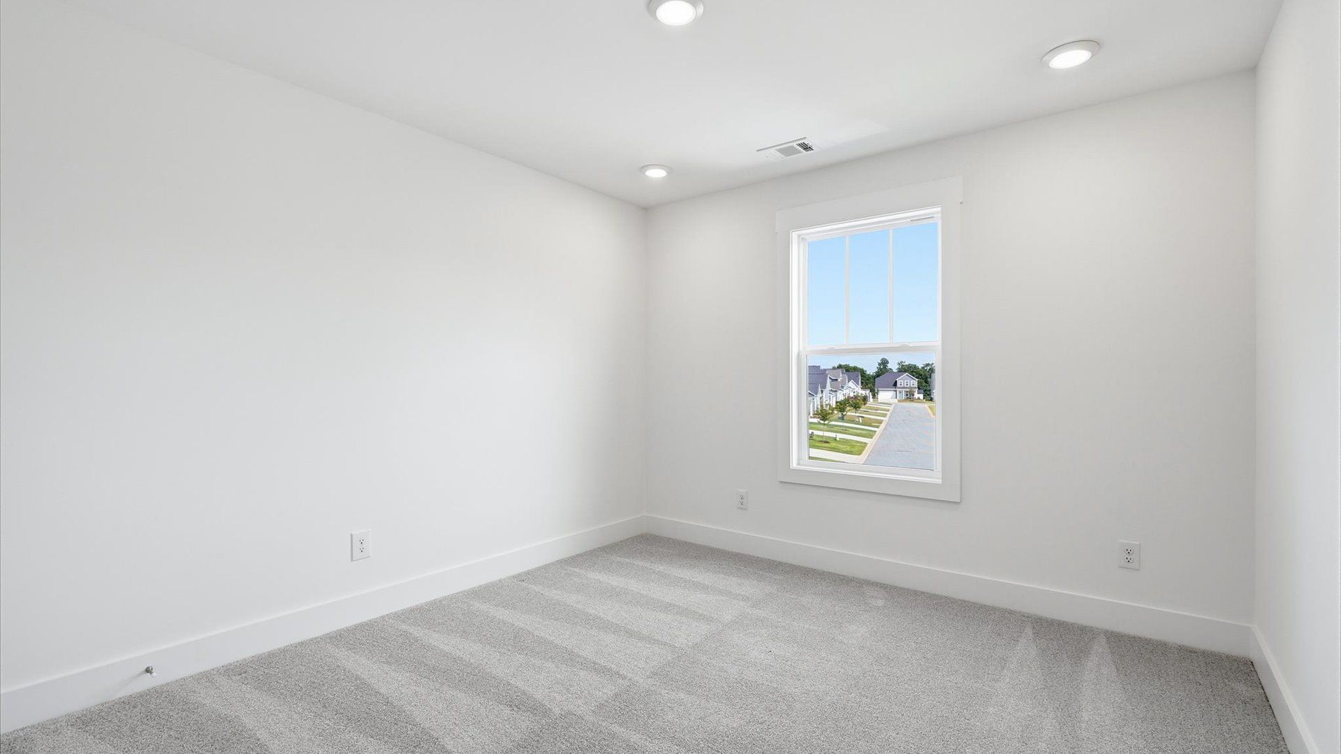 First-class bedroom with generous proportions, a walk-in closet, and beautiful natural light through large windows