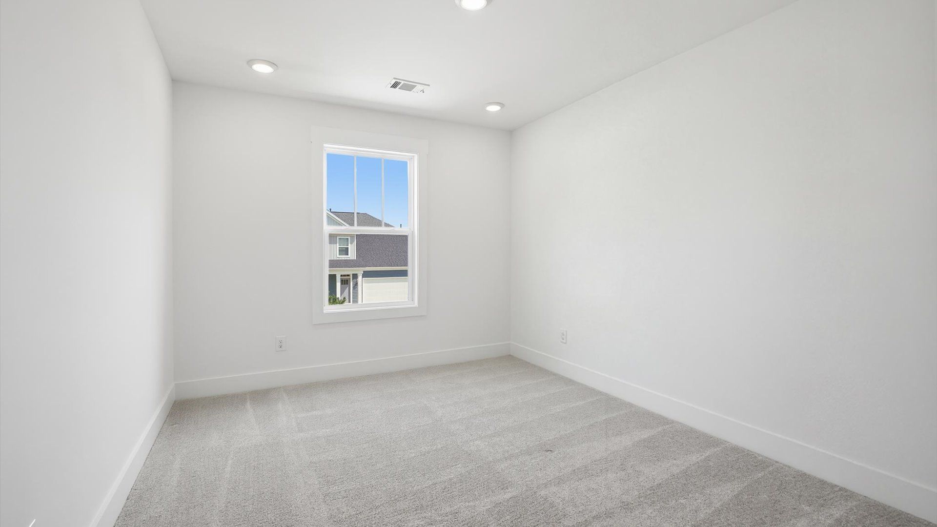 Refined bedroom design with a large window for daylight-filled mornings and peaceful views in Moore, SC