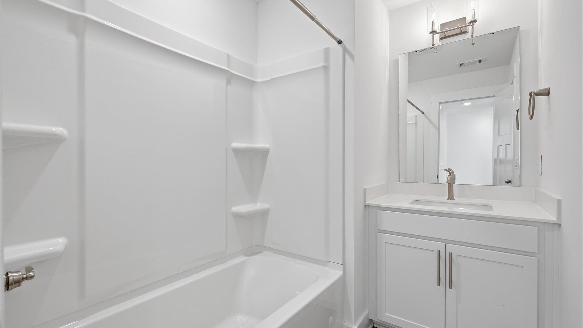 Elegant full bathroom with tasteful finishes and a thoughtfully designed layout by DRB Homes