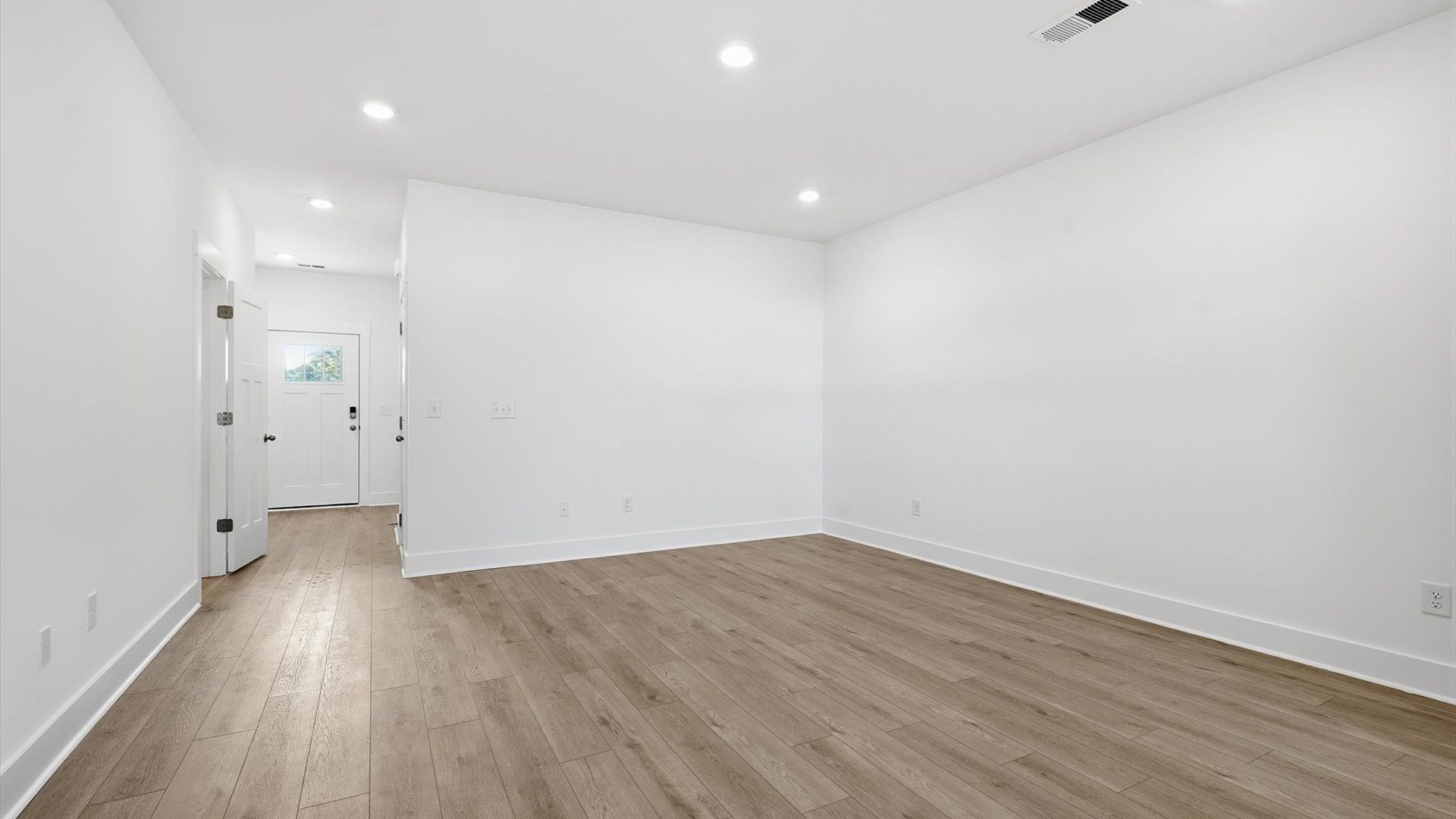 Elegant family room featuring hardwood flooring and thoughtful architectural detail at the Saluda Crossing community