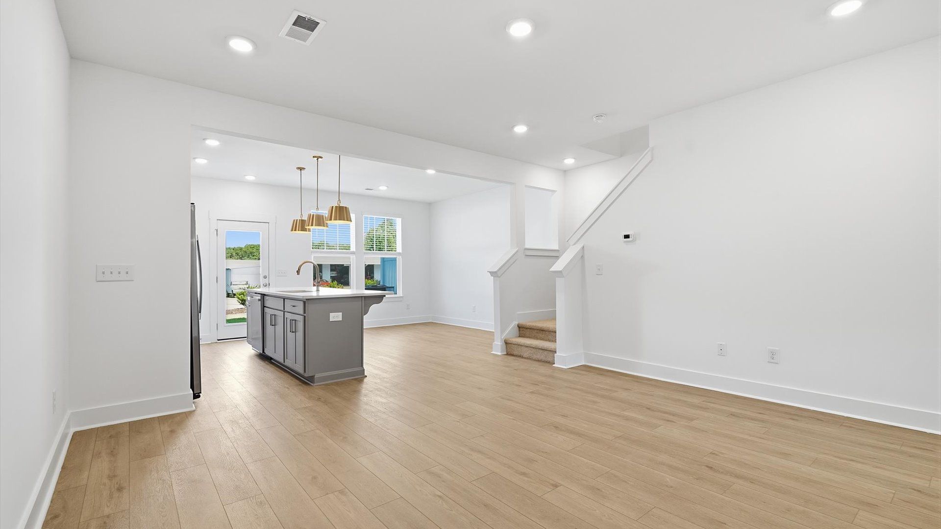 Spacious family room with rich hardwood flooring and elegant trim work in a reputable DRB Homes build