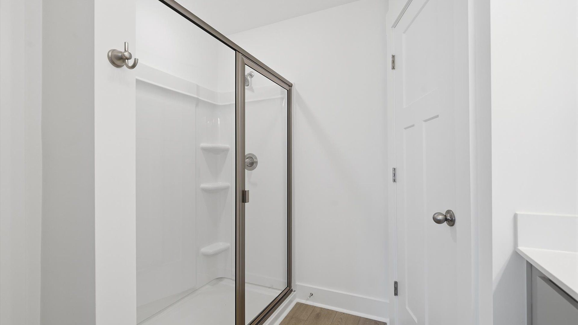Spacious and modern primary bathroom with walk-in shower and first-class double vanity setup
