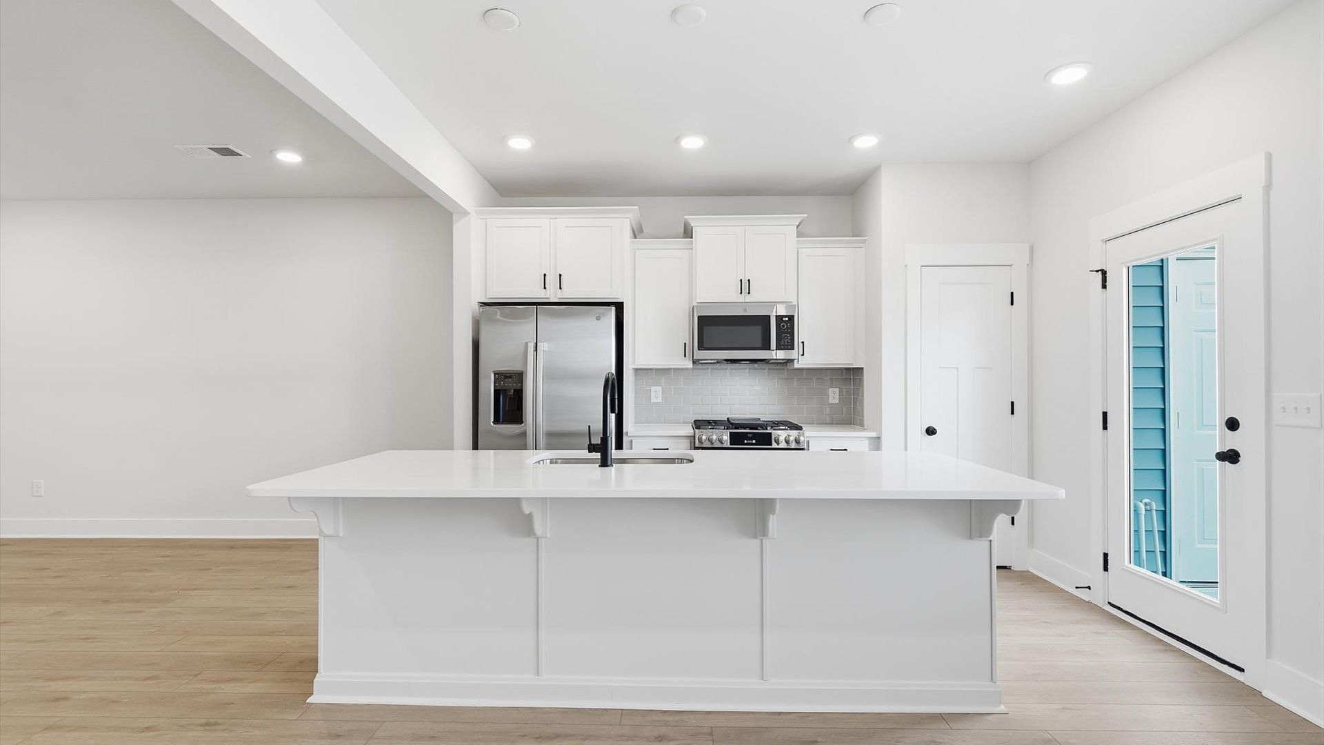 Tasteful kitchen with a streamlined island and modern finishes in a first-class DRB Homes design
