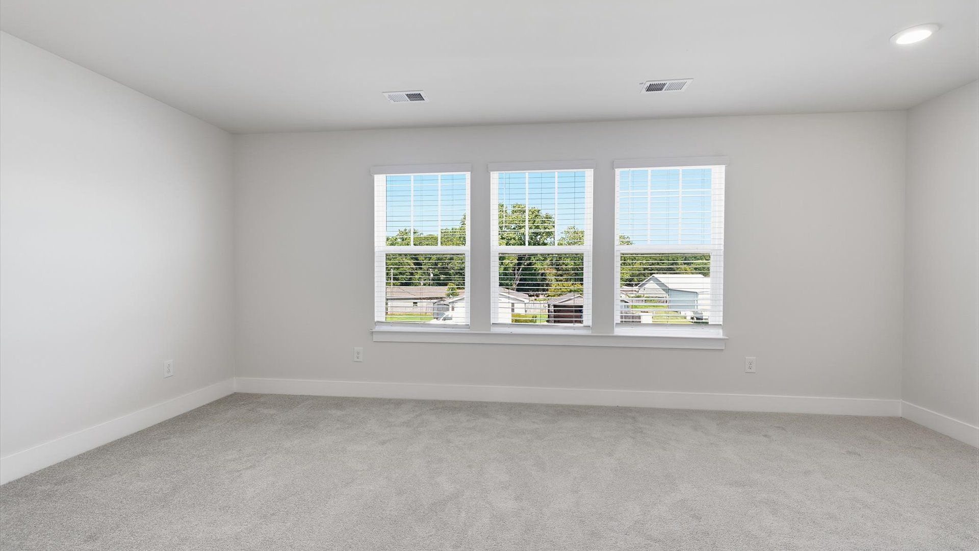 Serene and stylish primary bedroom featuring carpeted flooring and a thoughtful, modern layout at Saluda Crossing
