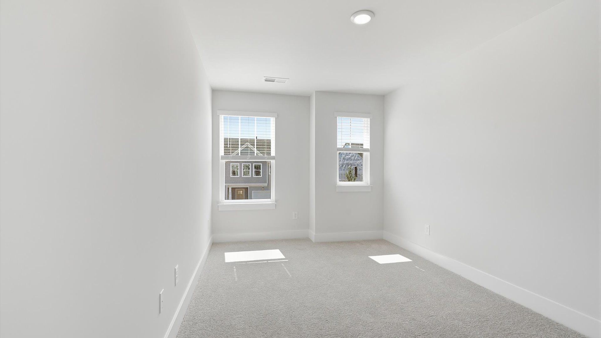 First-class bedroom with generous proportions, a walk-in closet, and beautiful natural light through large windows