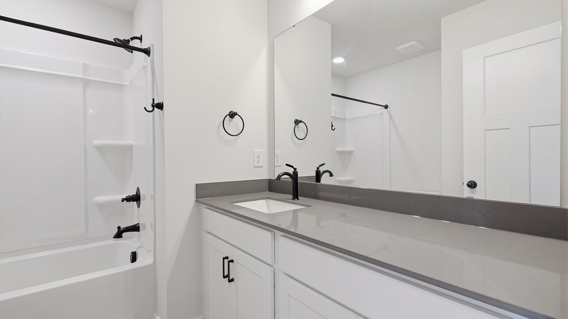 Top-notch bathroom with current fixtures, tasteful materials, and elevated charm by DRB Homes