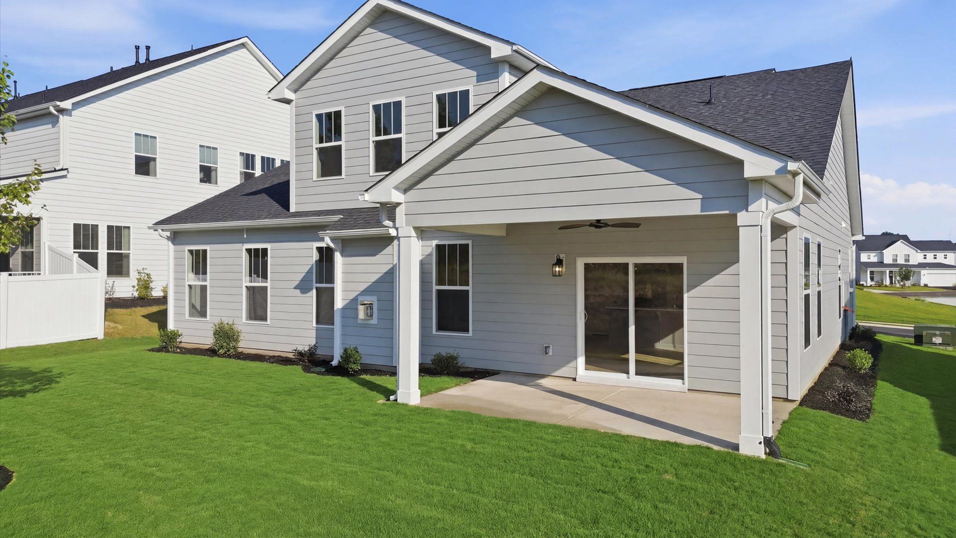Highly functional rear covered porch adds memorable living space to this elegant home located at Wells Crossing
