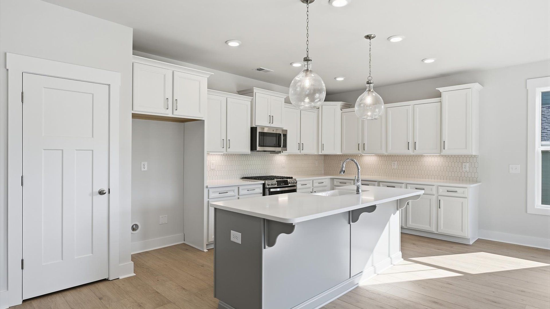 Tasteful kitchen with a streamlined island and modern finishes in a first-class DRB Homes design