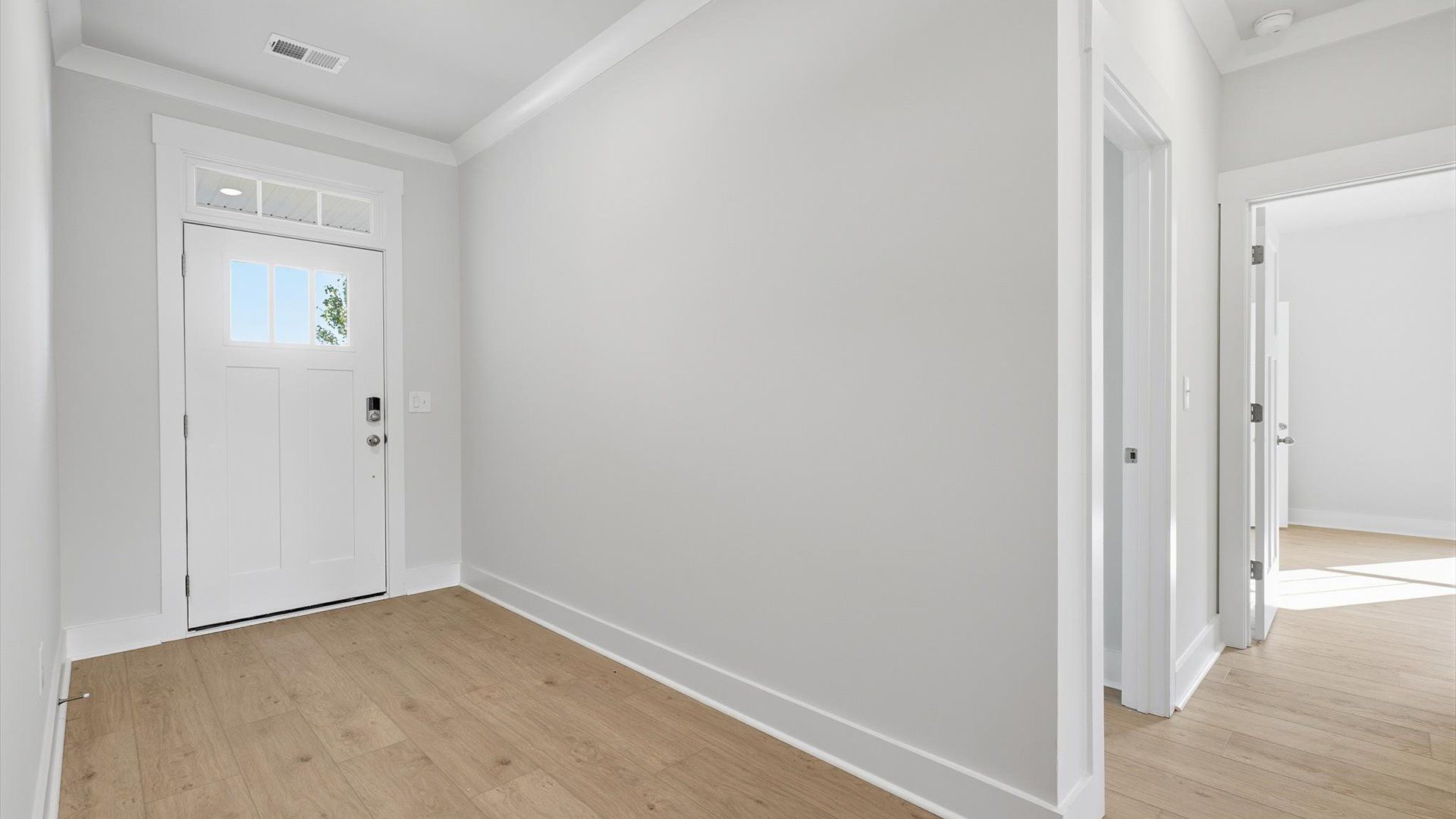 Superior design begins at the front door with a hardwood floor foyer and elegant sightlines at Wells Crossing