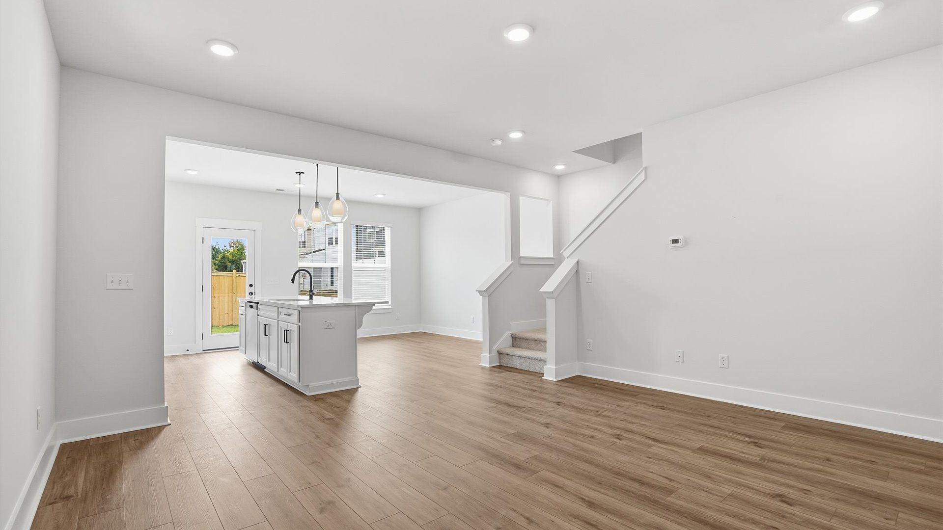 Spacious family room with accomplished design and eye-catching details throughout at the Barton Hollow community