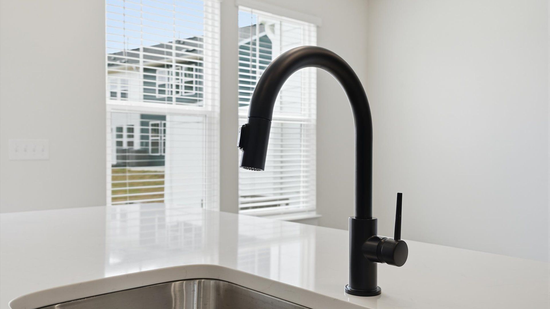 Elegant kitchen with large island and stylish hardware in this first-class DRB Homes design
