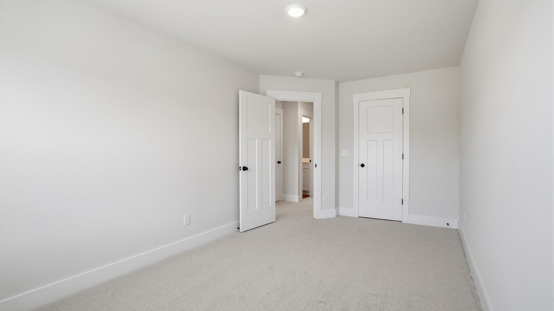 Superior comfort in a secondary bedroom with plush carpet and an oversized walk-in closet in Fountain Inn, SC