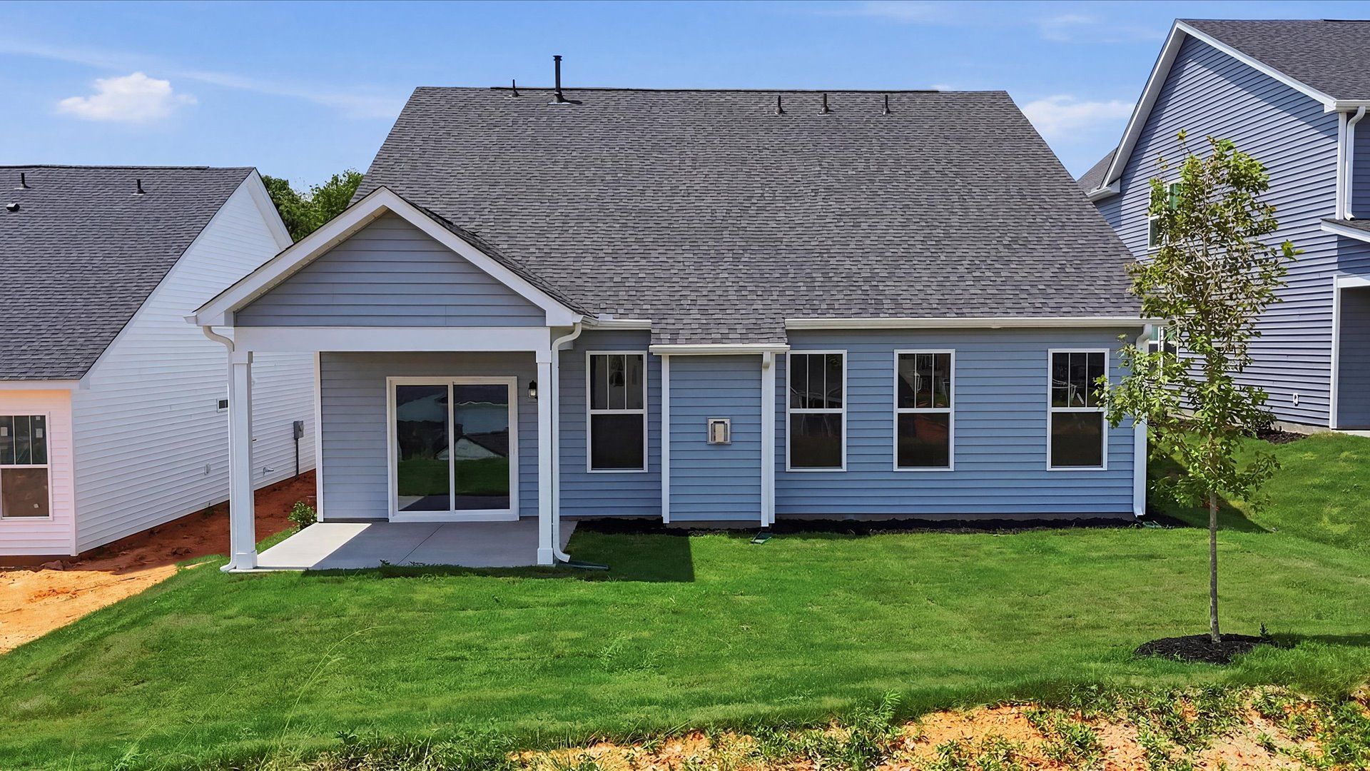 Highly functional rear covered porch adds memorable living space to this elegant home located at Iris Meadows