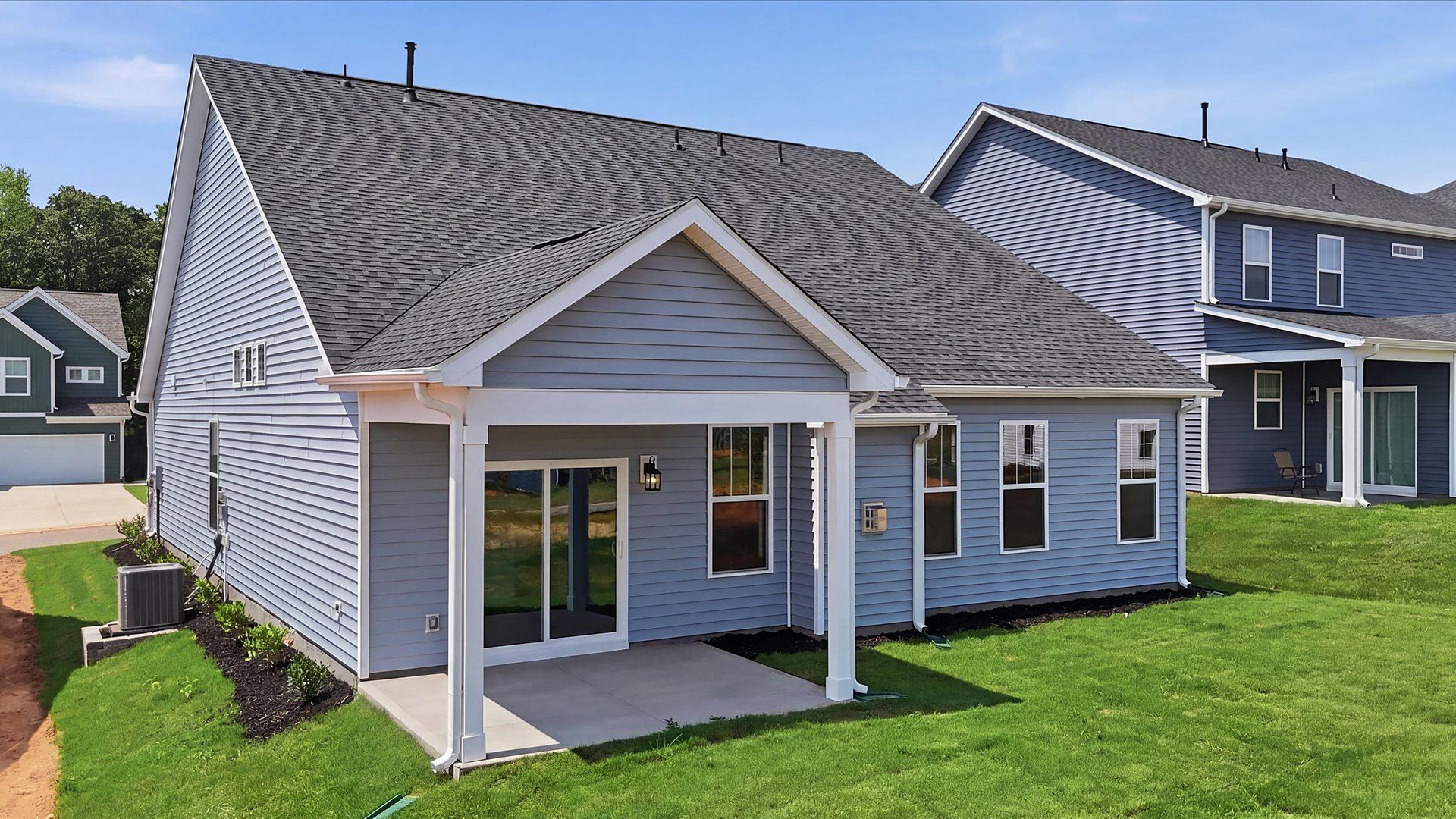 Elegant exterior with a rear covered porch—perfect for relaxing or entertaining outdoors at the Iris Meadows community