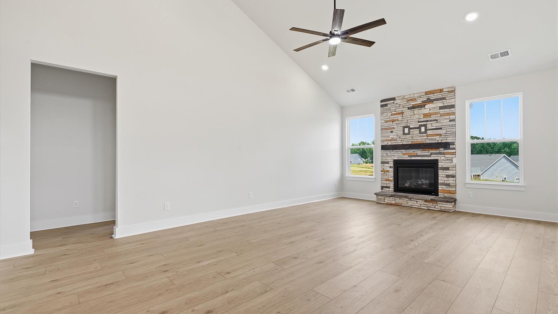 Highly skilled craftsmanship and modern elegance meet in this family room with soaring ceilings by DRB Homes