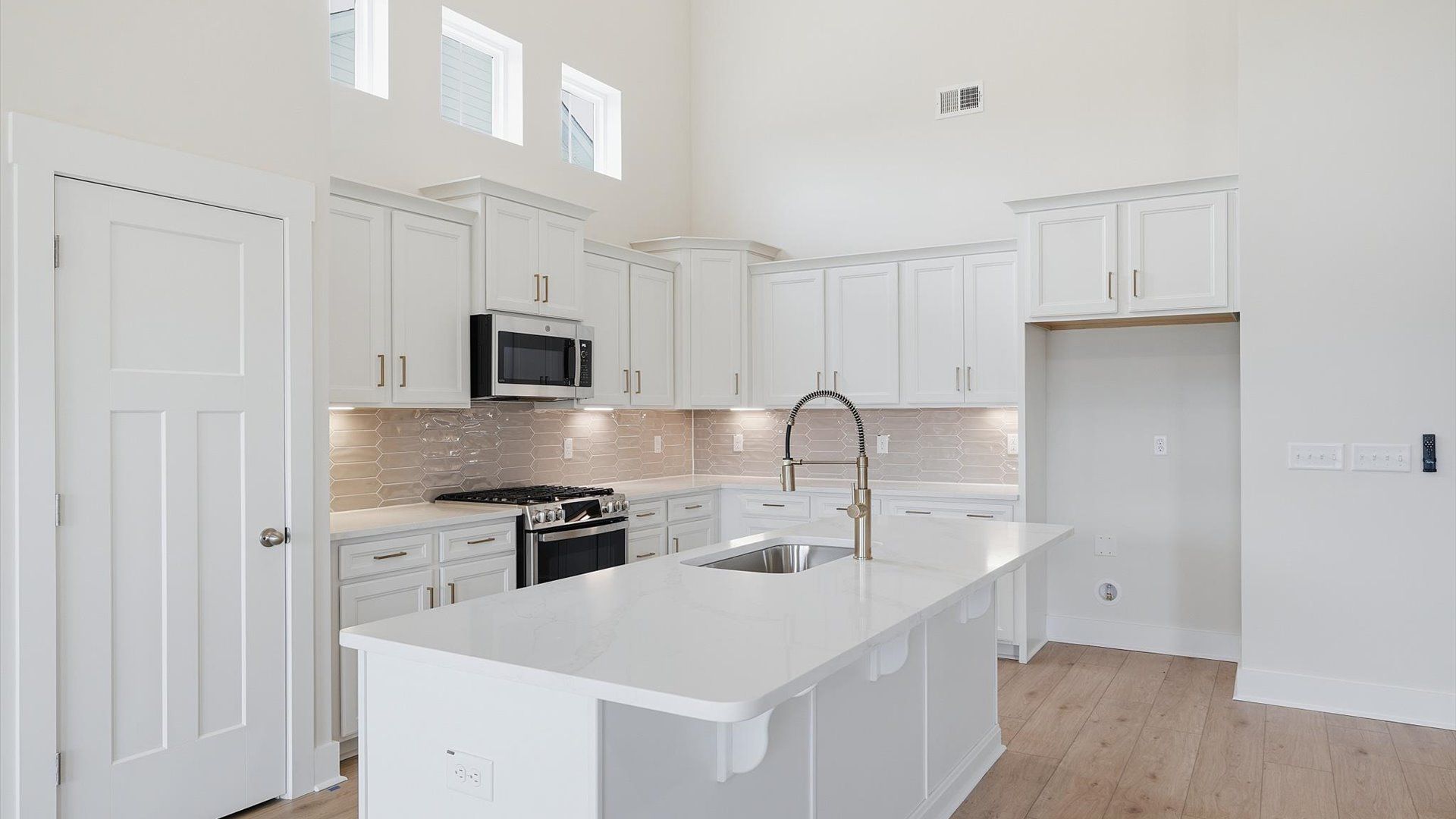 Tasteful kitchen with a streamlined island and modern finishes in a first-class DRB Homes design