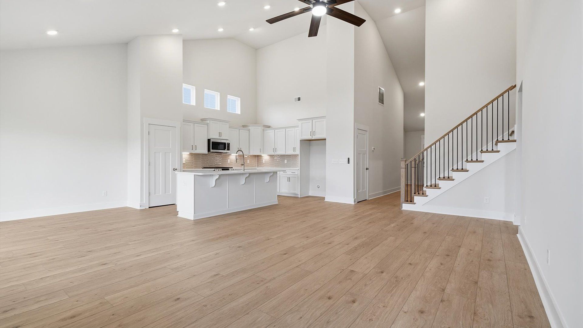 Hardwood flooring and high standards define this vibrant family room ideal for everyday living at the Iris Meadows community