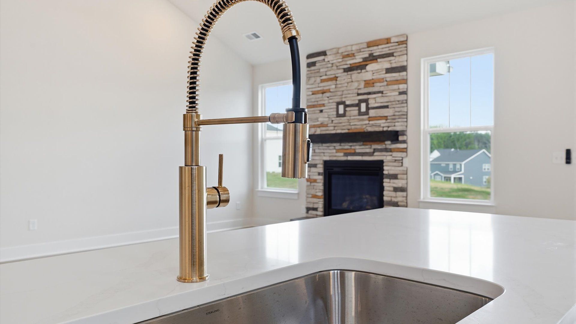 Top-notch kitchen featuring quartz countertops, open sightlines, and bronze hardware by the reputable DRB Homes
