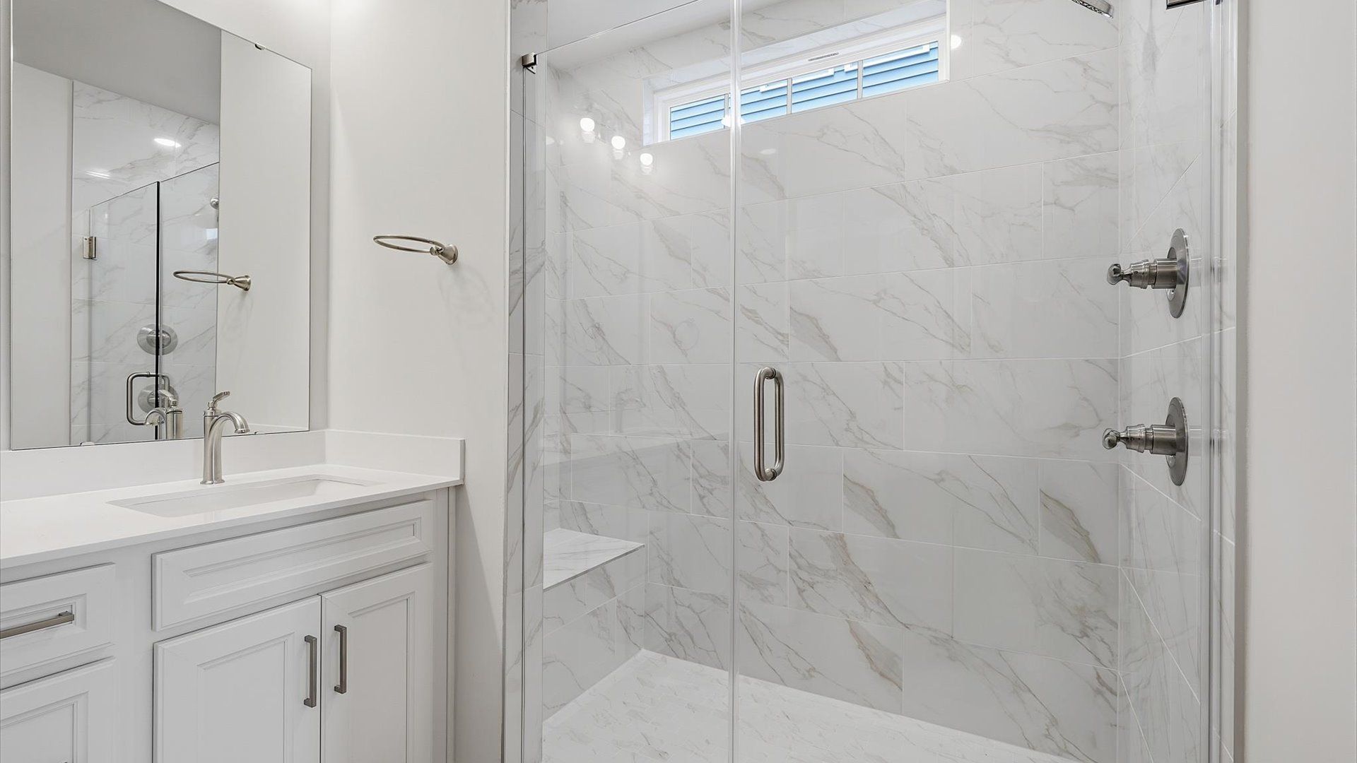 Elegant primary bathroom featuring a spacious walk-in shower in this first-class DRB Homes design