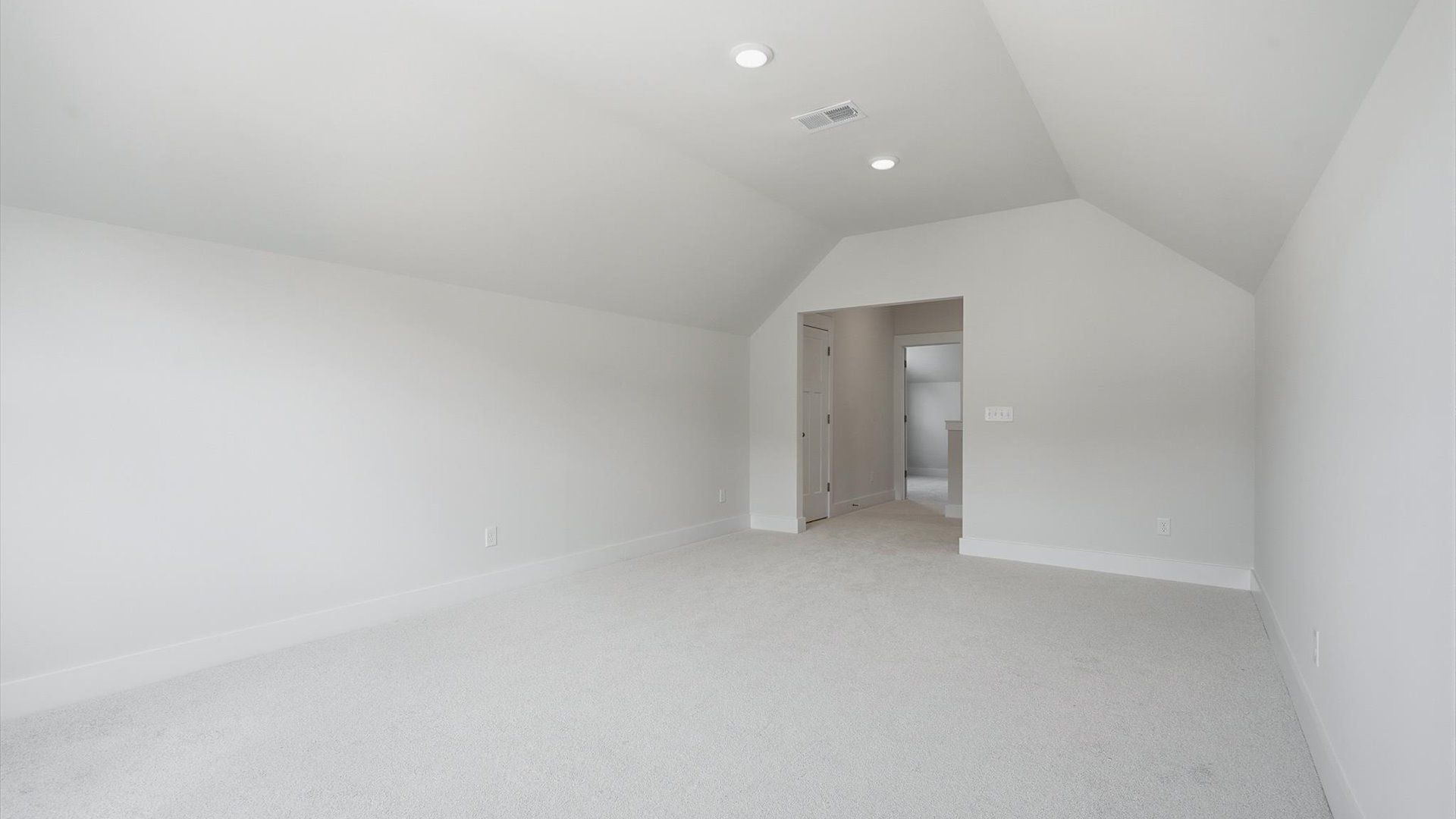Top-notch design defines this upstairs bonus room with carpeted floors and an open, airy layout