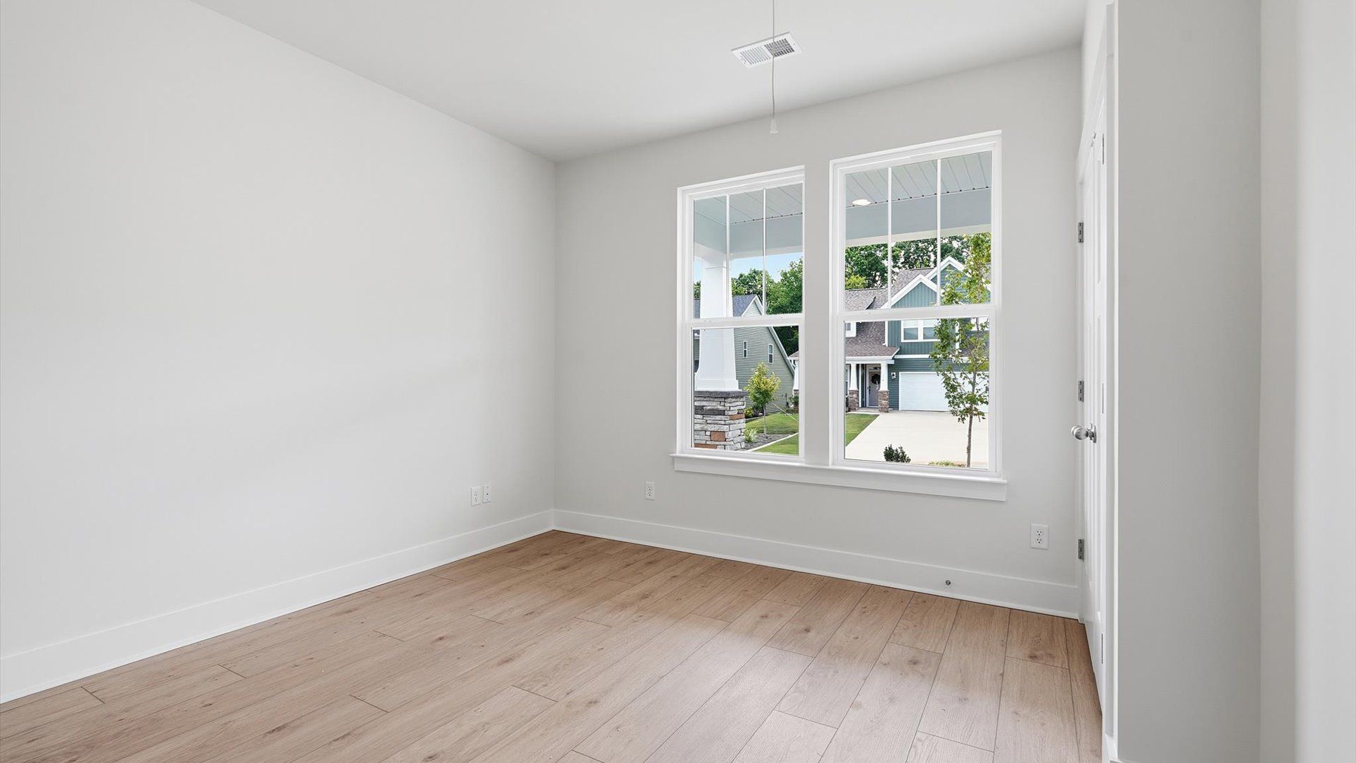 Inviting bedroom with tasteful finishes and large windows that create a fresh, open ambiance in Moore, SC