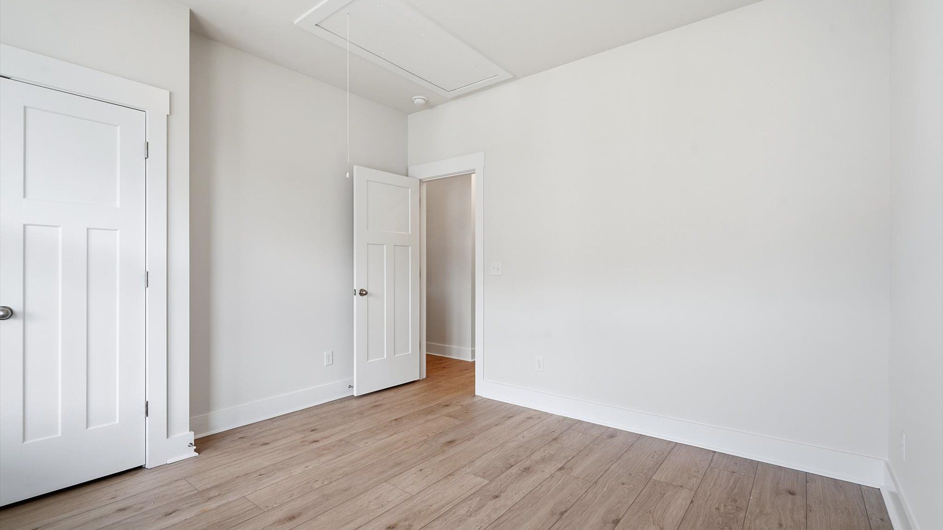 Thoughtfully designed secondary bedrooms featuring hardwood flooring and tasteful detail by DRB Homes