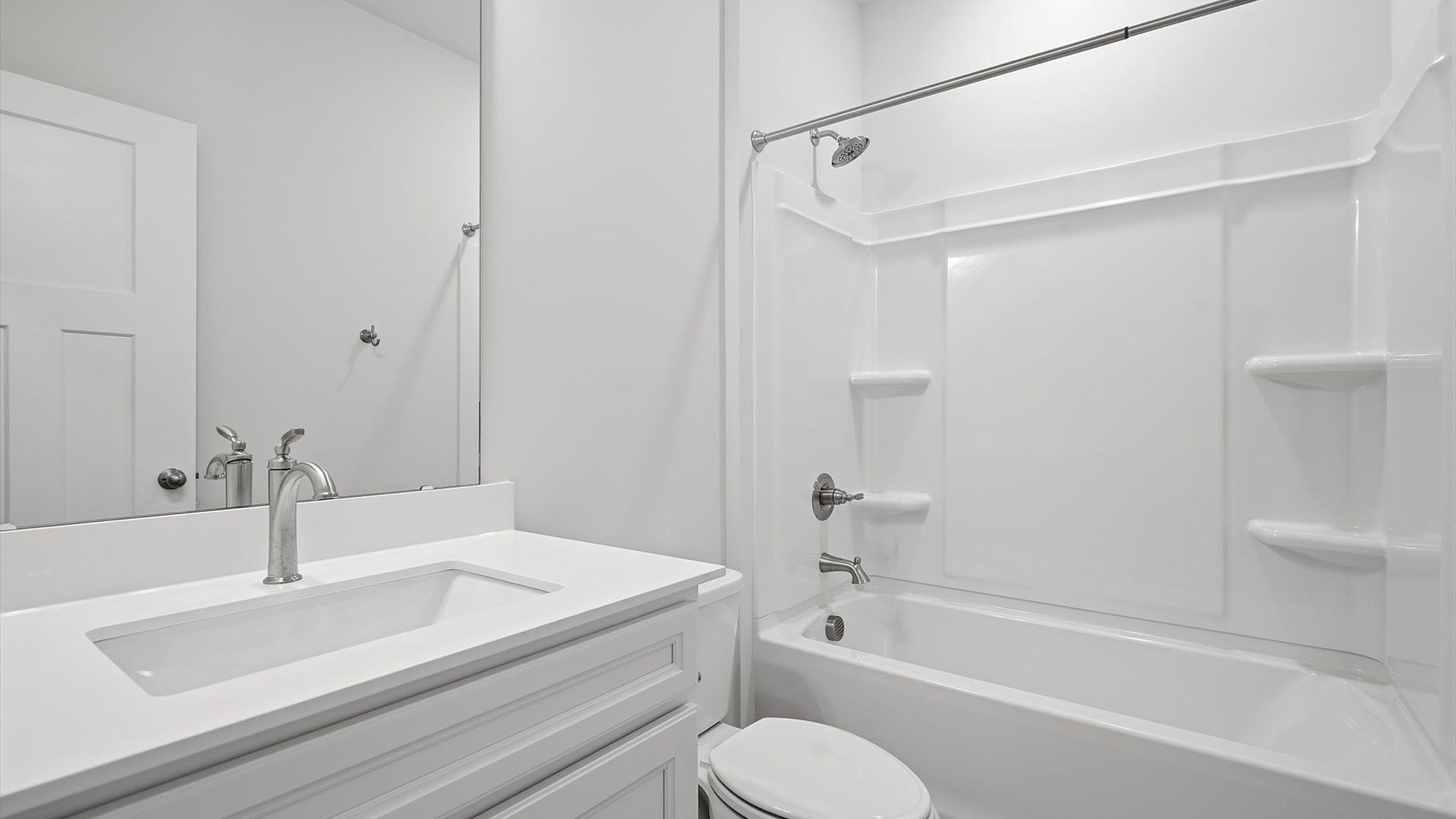 Accomplished bathroom design with sleek tile, high-quality cabinetry, and refined hardware at Iris Meadows