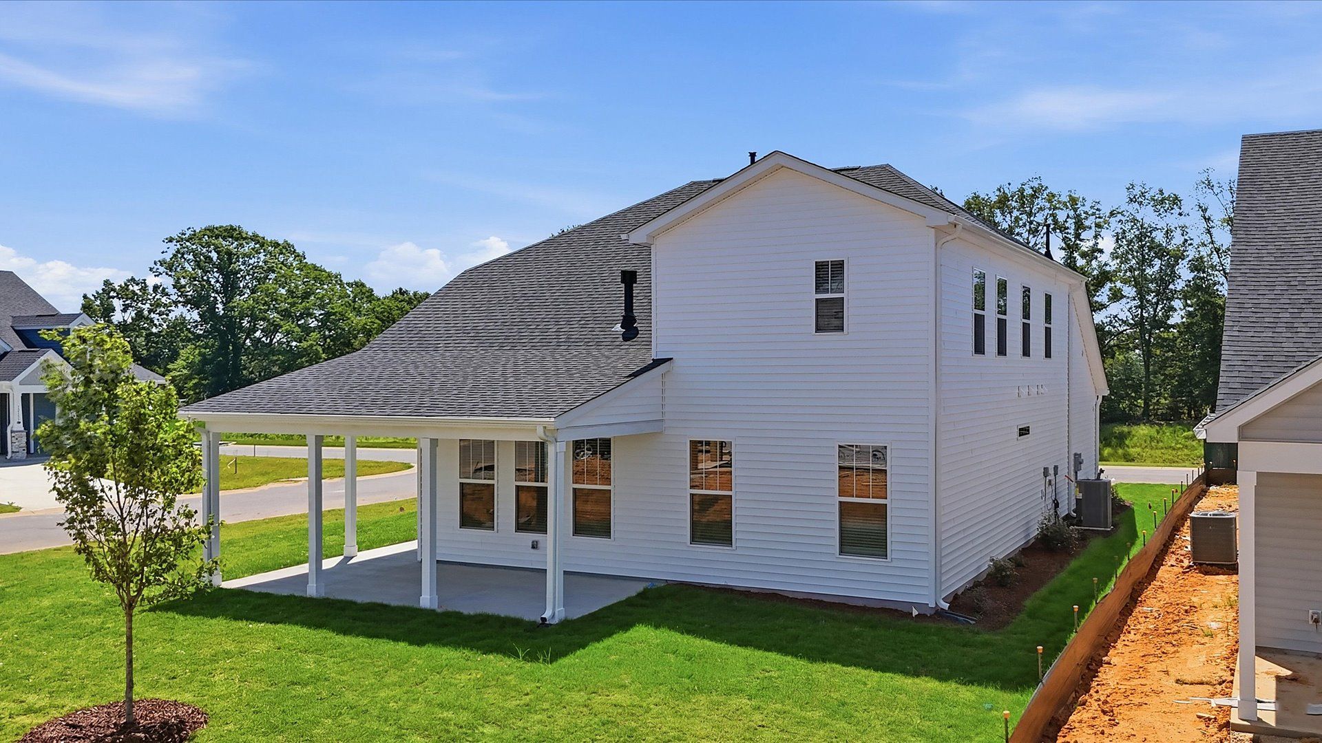 Refined rear exterior with a stylish covered porch for dining, relaxing, or entertaining by DRB Homes