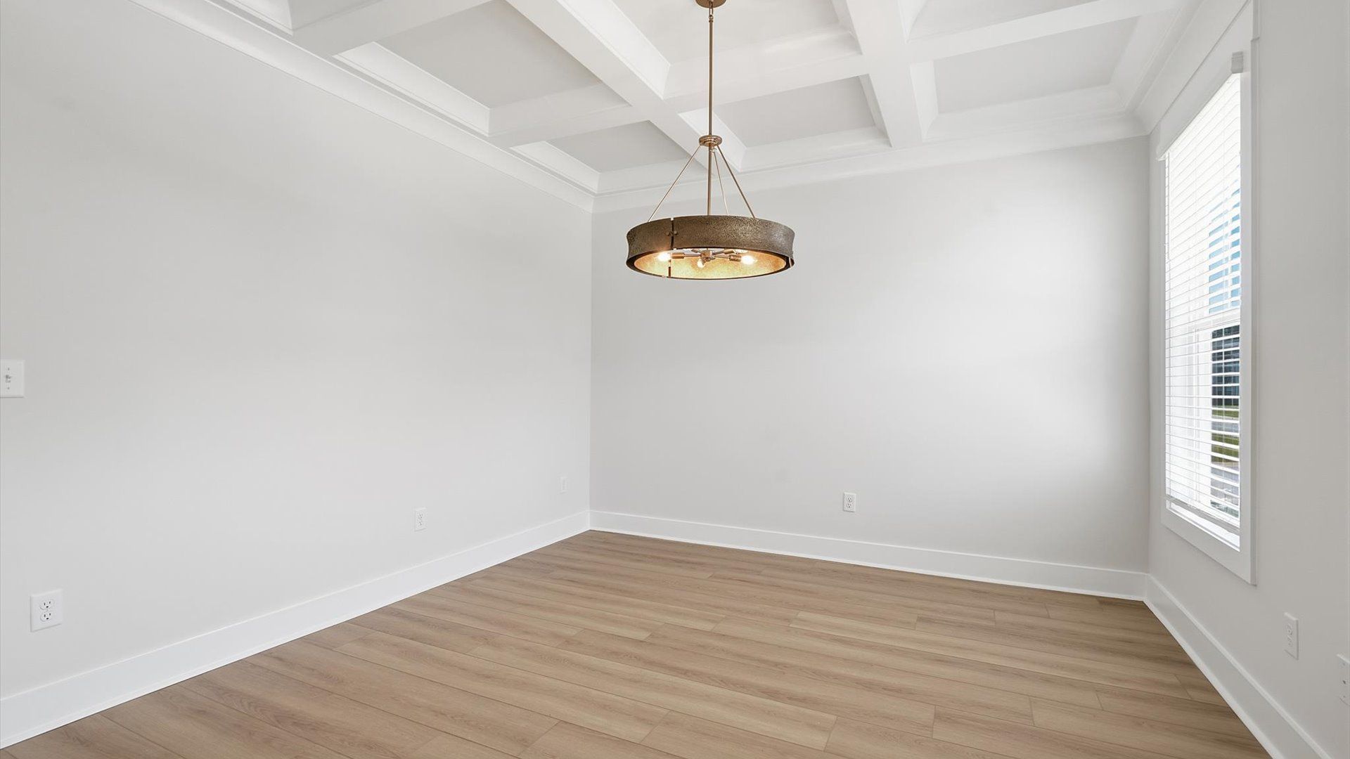 Coffered ceiling detail brings depth and sophistication to this top-notch formal dining room near Lake Bowen